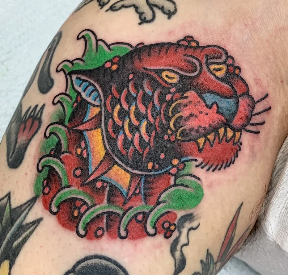 Traditional aquatic panther tattoo