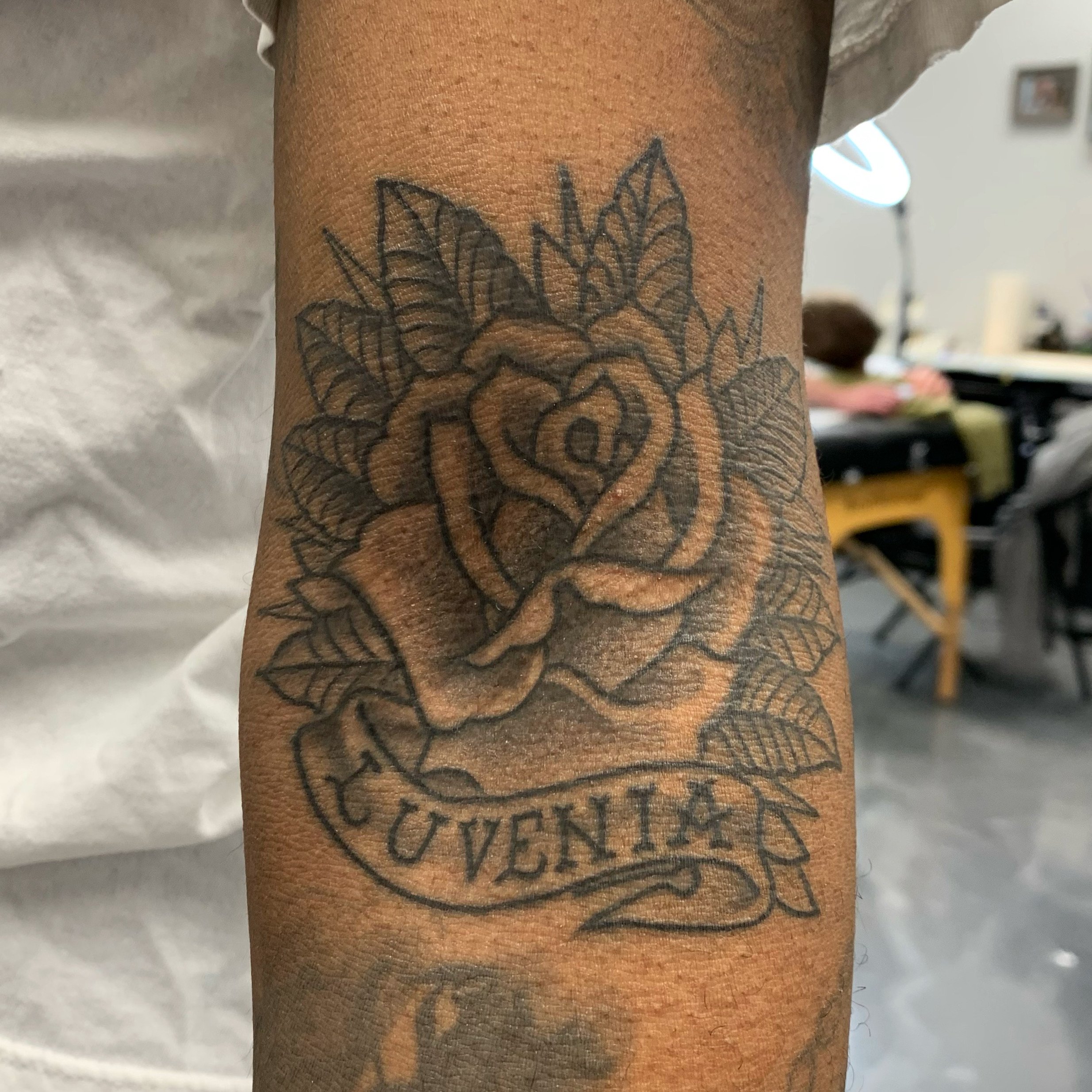 Healed traditional rose tattoo in an elbow ditch