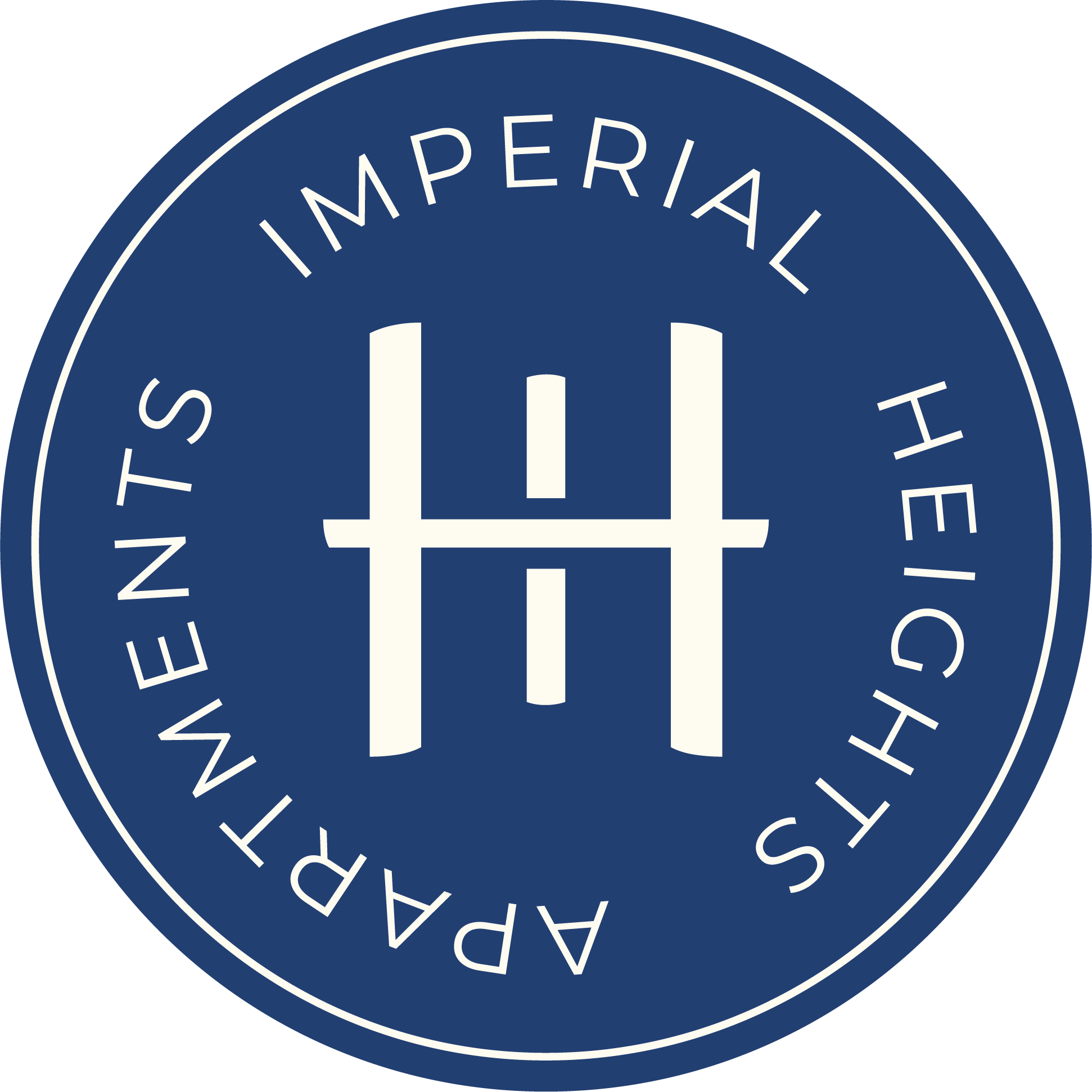 Close-up of a circular emblem with a dark blue background and white text that reads "Imperial State" and "Patriotism" around the outer edge, with a stylized white castle or fortress in the center.