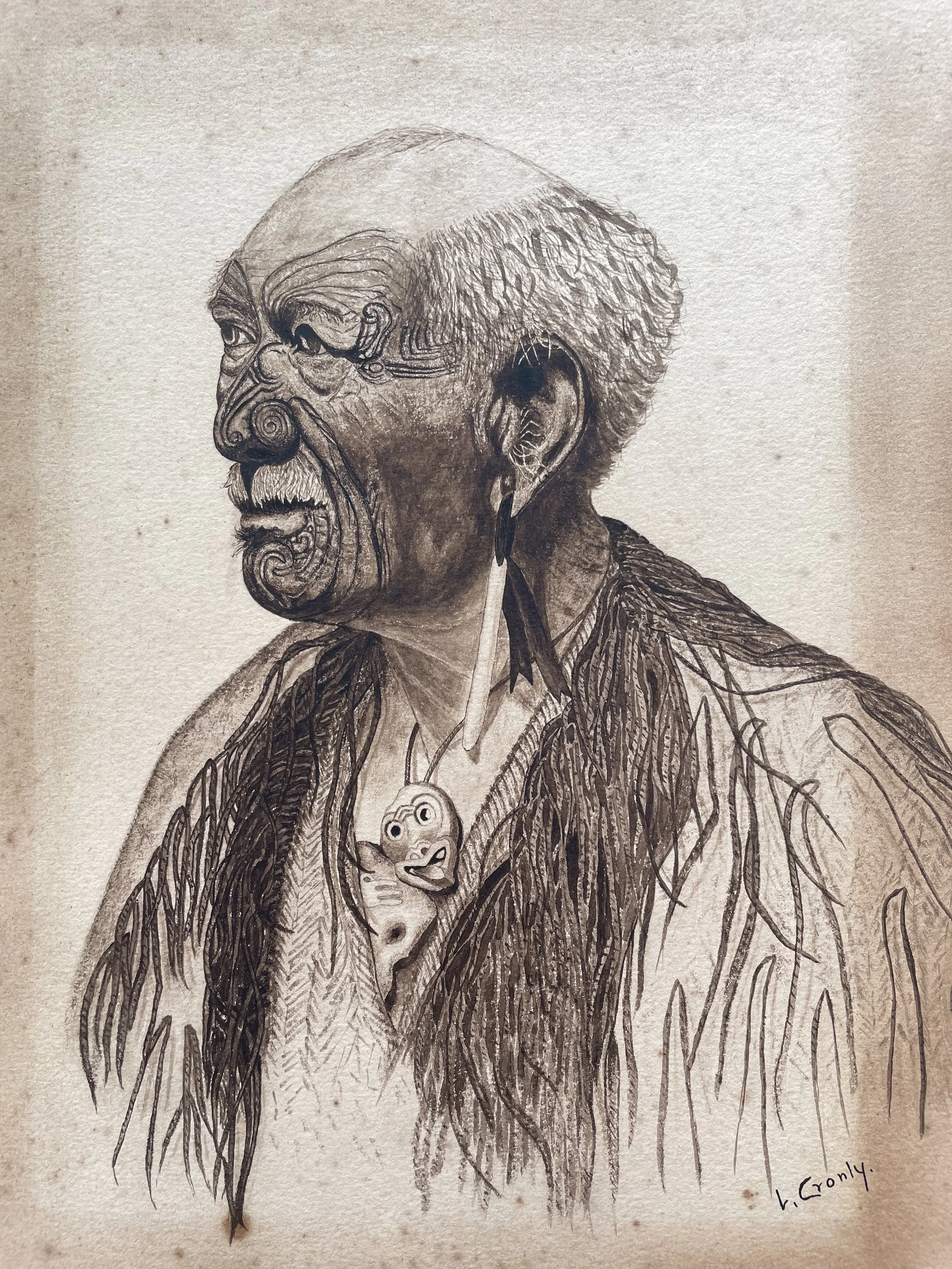 A detailed pencil drawing of an elderly man with exaggerated facial features, tribal scars, and long, flowing hair. The man wears a necklace with a pendant shaped like a face.