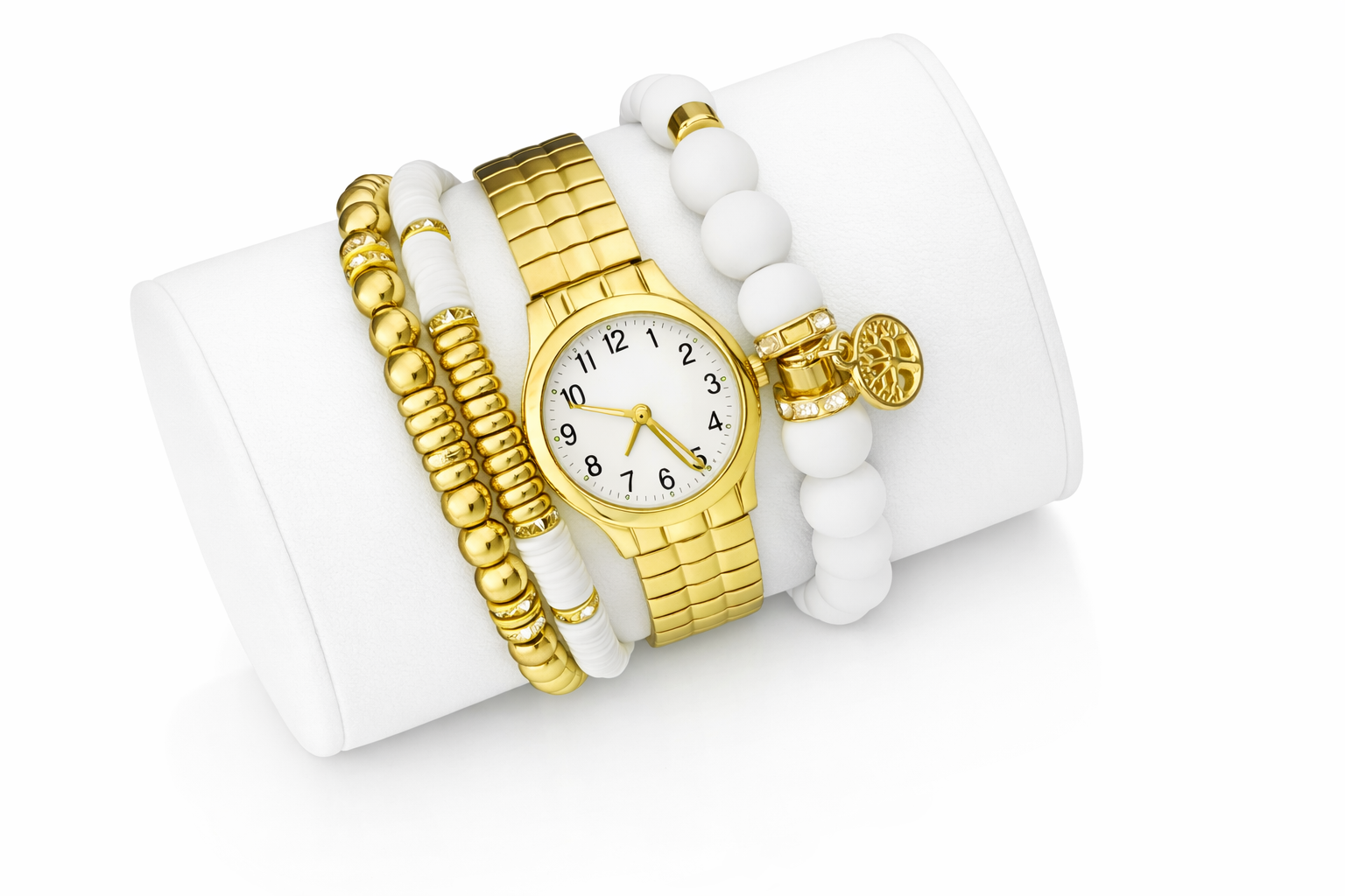 Gold watch with white dial and three gold and white bracelets on a white display stand.