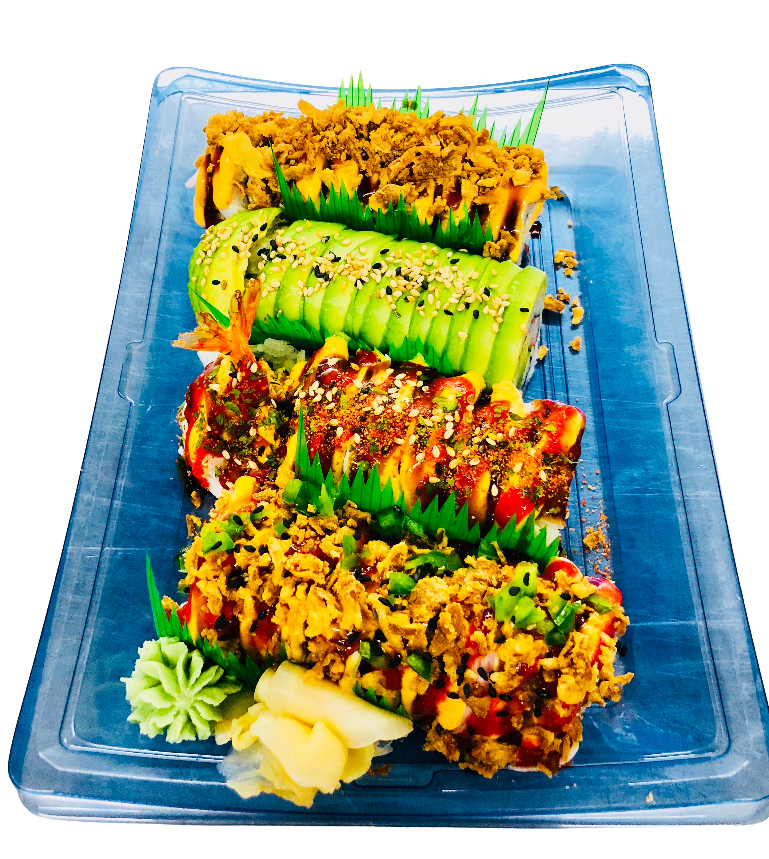 Sushi platter with various types of sushi, including avocado-topped and fried toppings, garnished with wasabi and pickled ginger, served on a clear plastic tray.
