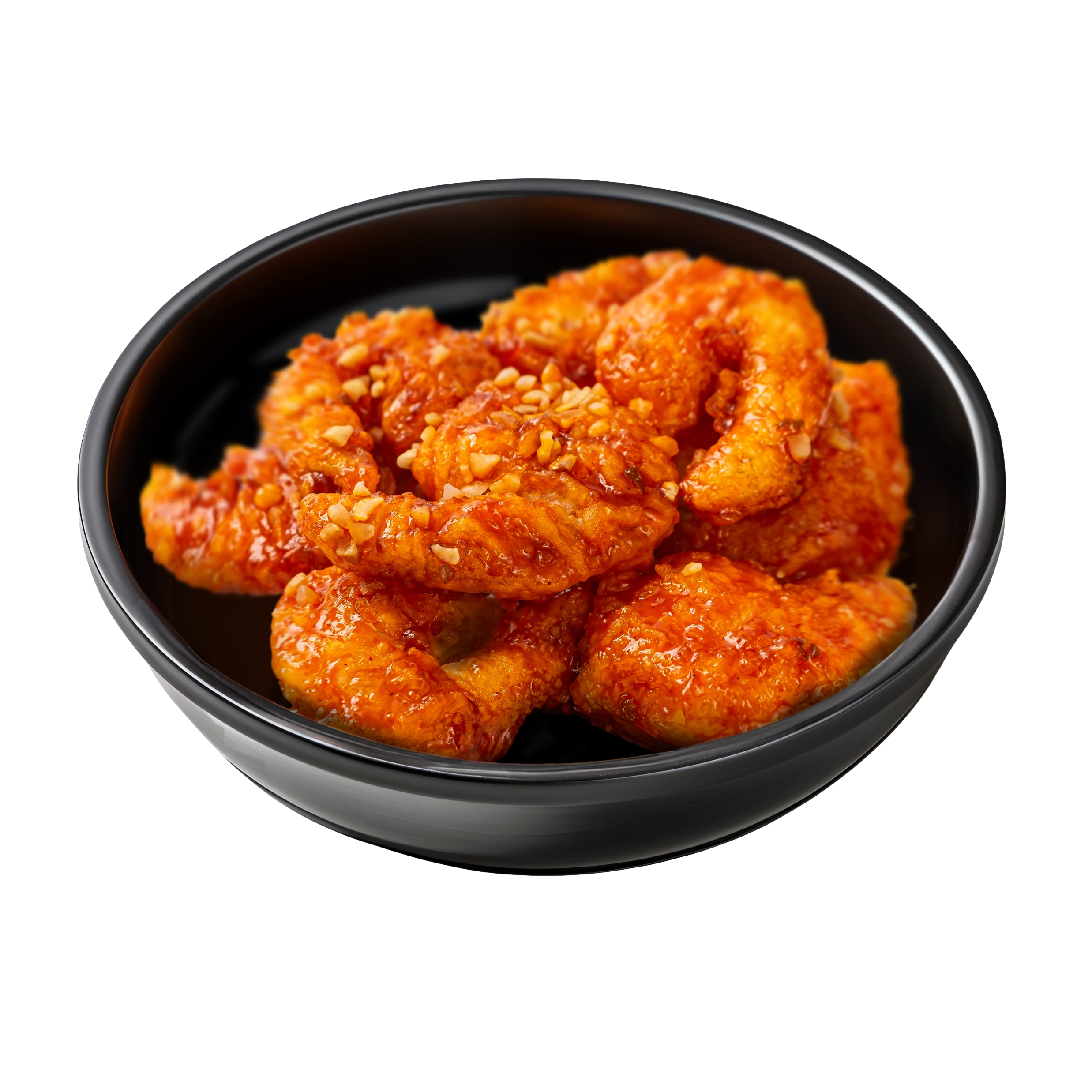 Close-up of a black bowl filled with orange-colored pieces of fried chicken coated in sauce and sprinkled with chopped peanuts.
