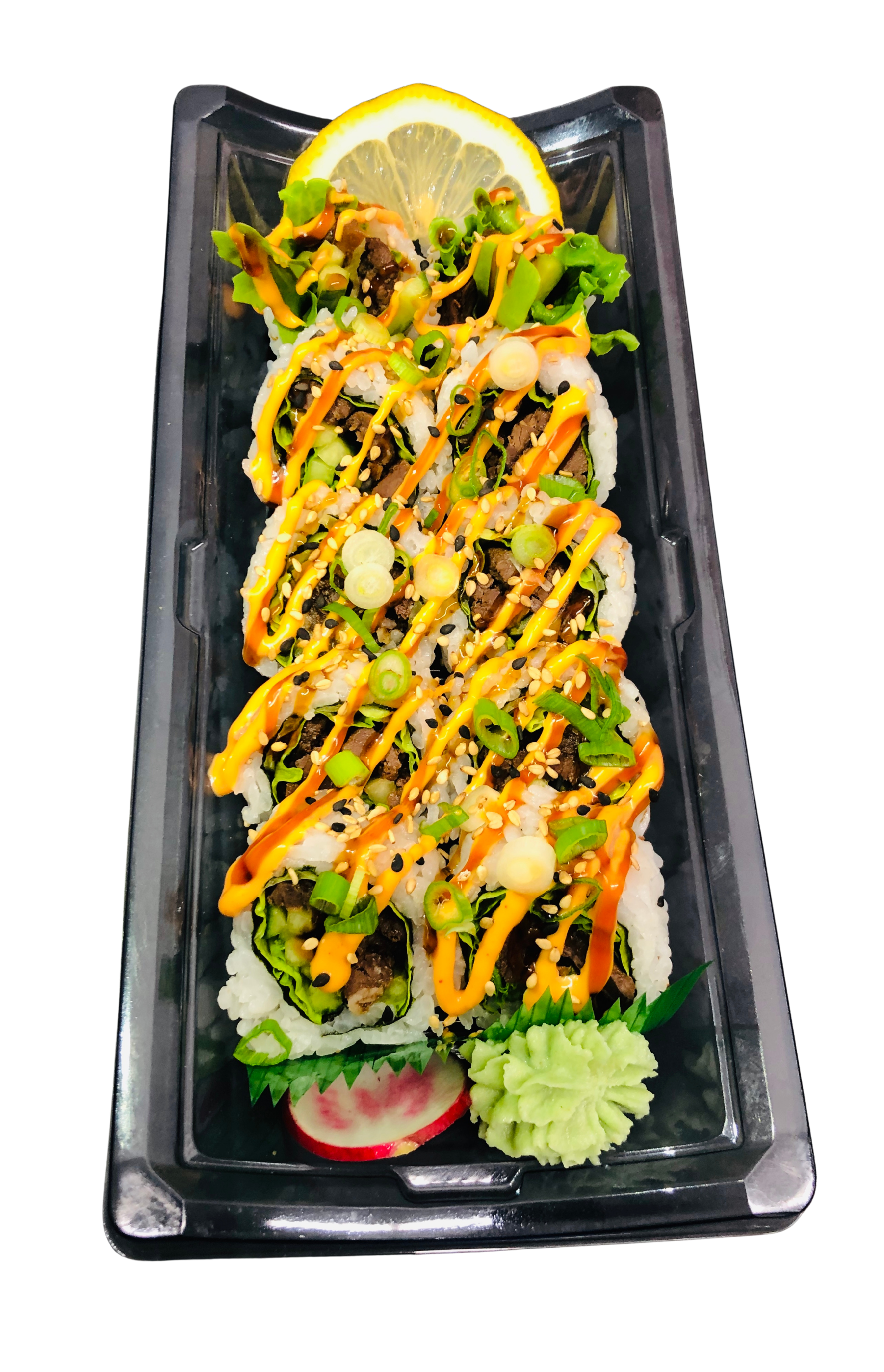 A plate of sushi rolls topped with orange sauce, green onions, and sesame seeds, with lemon slices, pickled ginger, and wasabi on the side.
