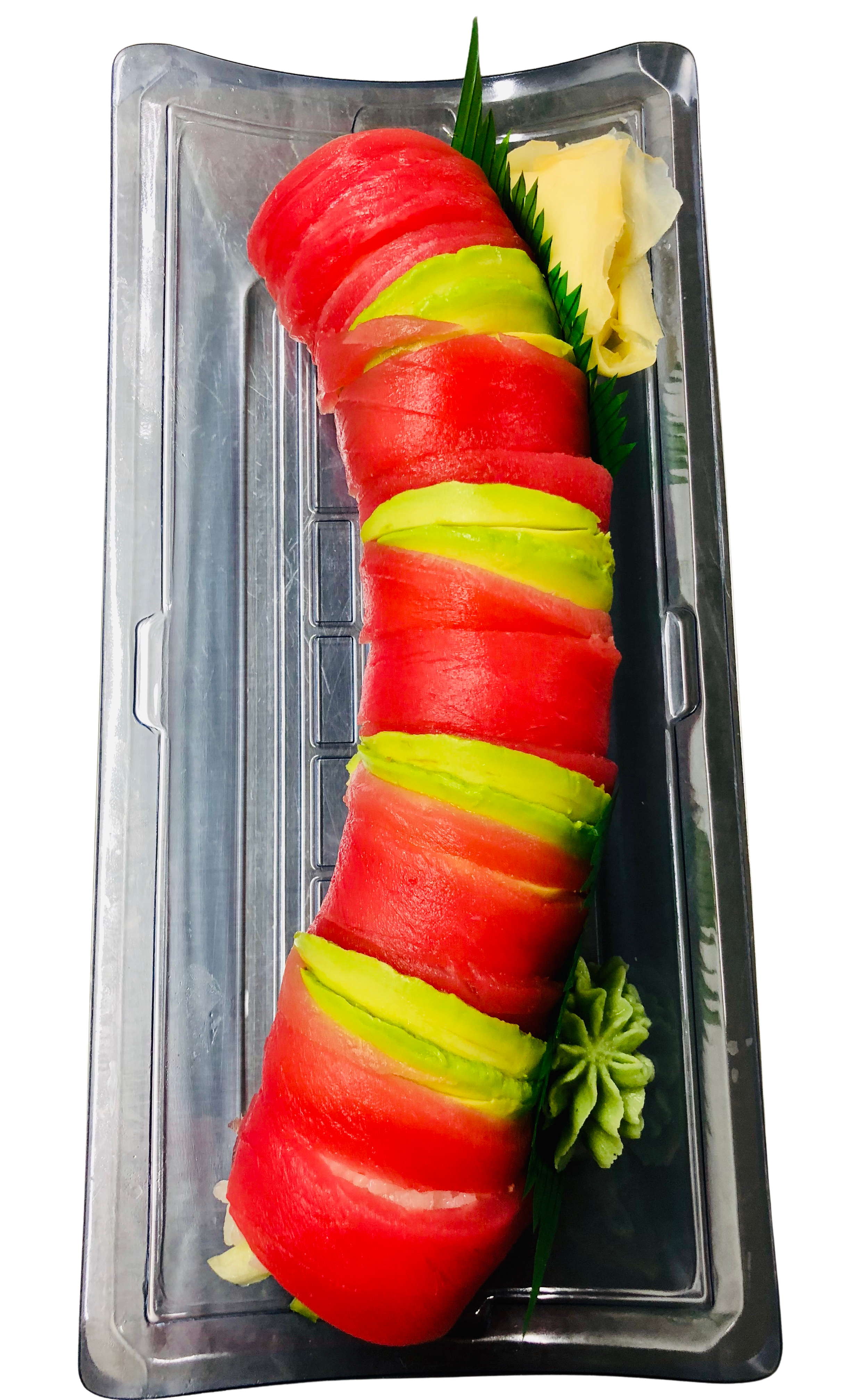 Sliced watermelon and avocado arranged on a plate garnished with green leaves and a small pile of wasabi.
