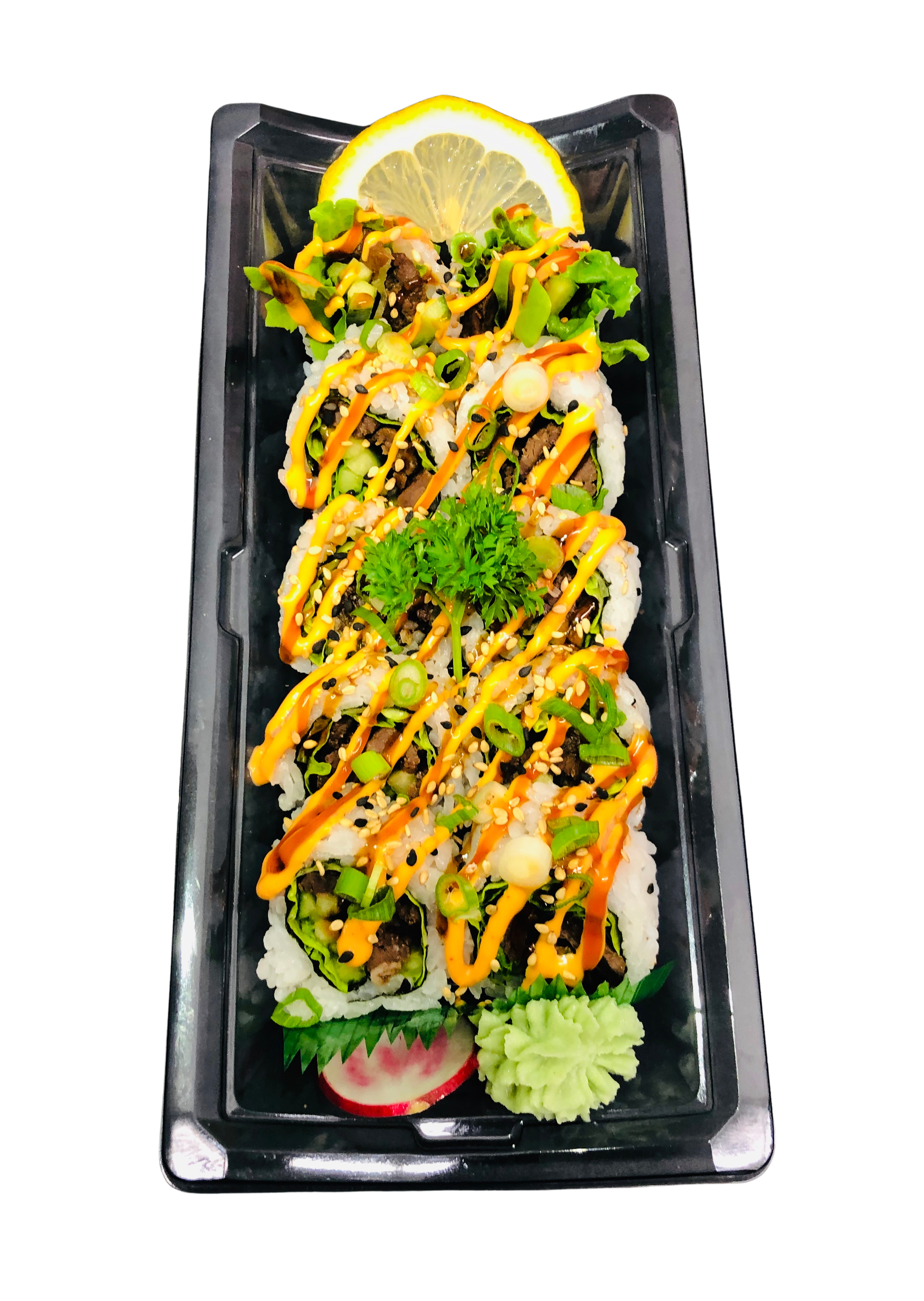 Sushi rolls topped with orange sauce and green onions, garnished with lemon slices, wasabi, ginger, and leafy greens on a black background.