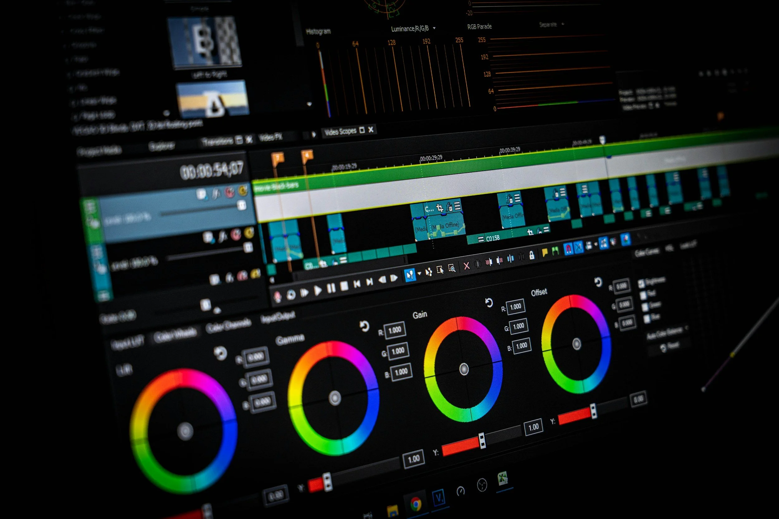 Computer screen displaying photo editing software with color grading tools, timelines, and color wheels.