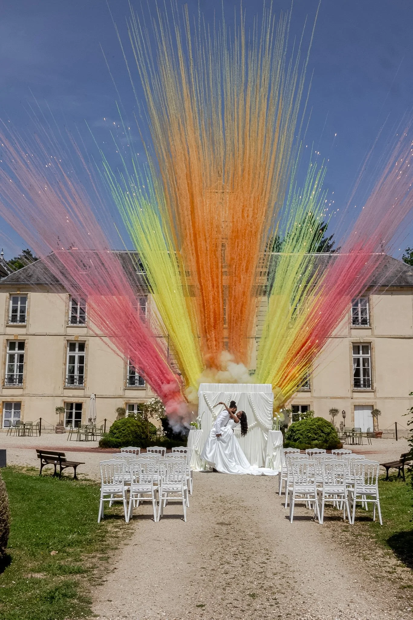 A joyful and artistic moment at Château d'Aveny, where elegance meets celebration. Captured with an editorial approach, this colorful wedding portrait showcases modern destination wedding inspiration in one of France's most charming château venues.