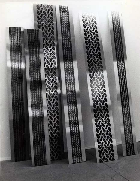 A display of tall, vertically standing decorative panels with various abstract black and white patterns.