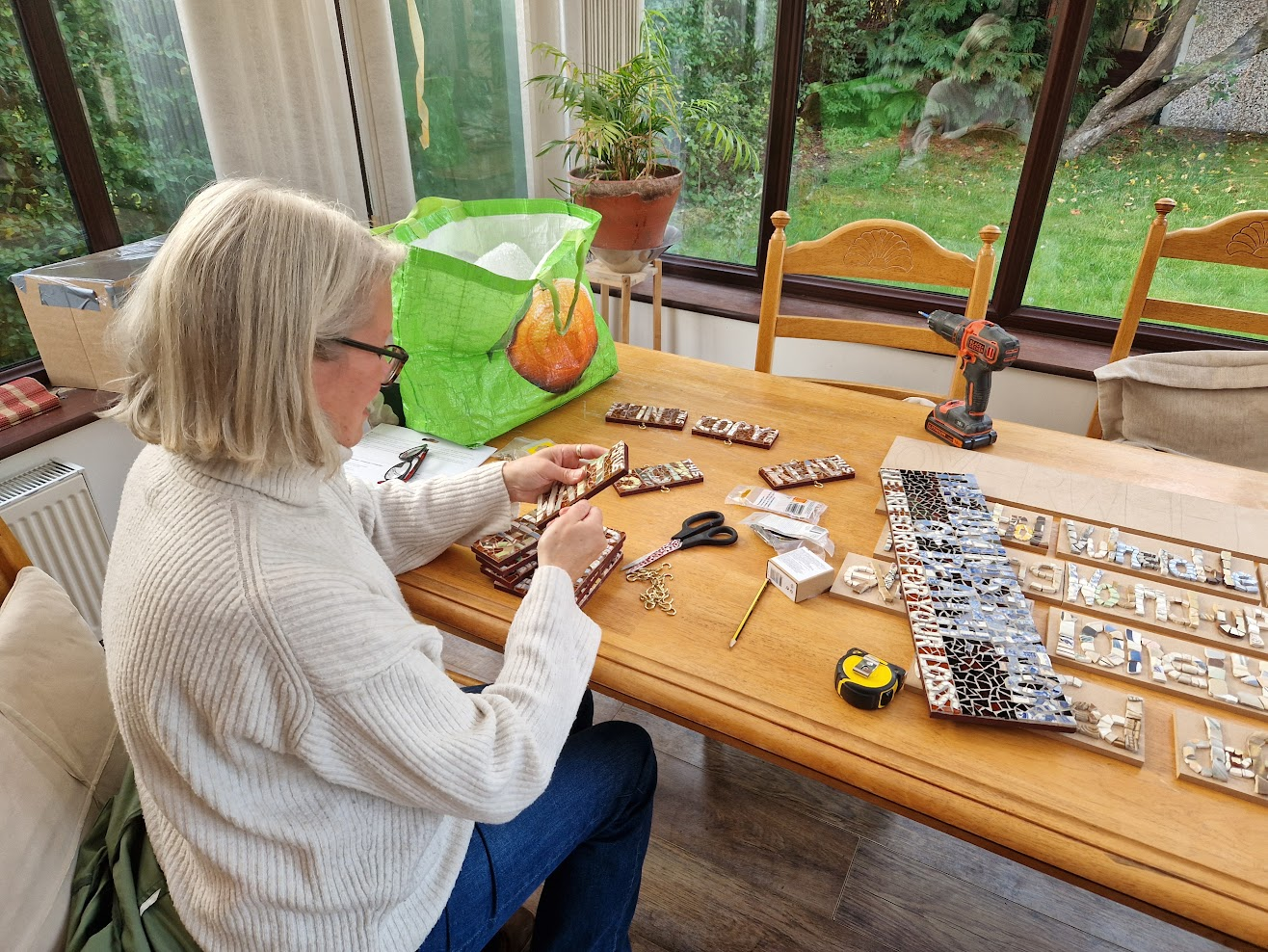 A photo of Jacky in the process of making her three mobiles displayed at the St Columba’s Art Fair exhibition.