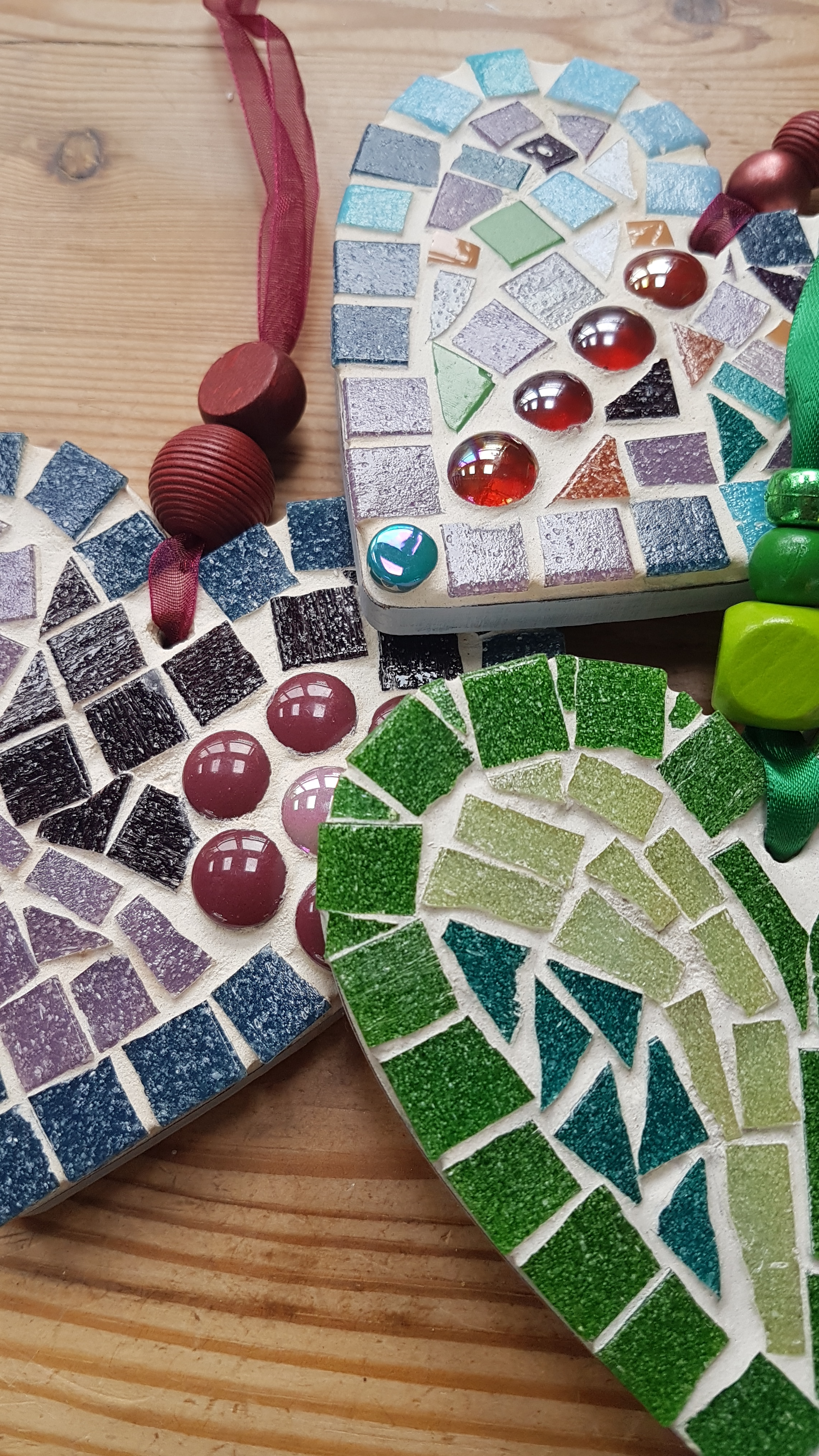 A close up of mosaic hearts using a colourful array of mosaic pieces