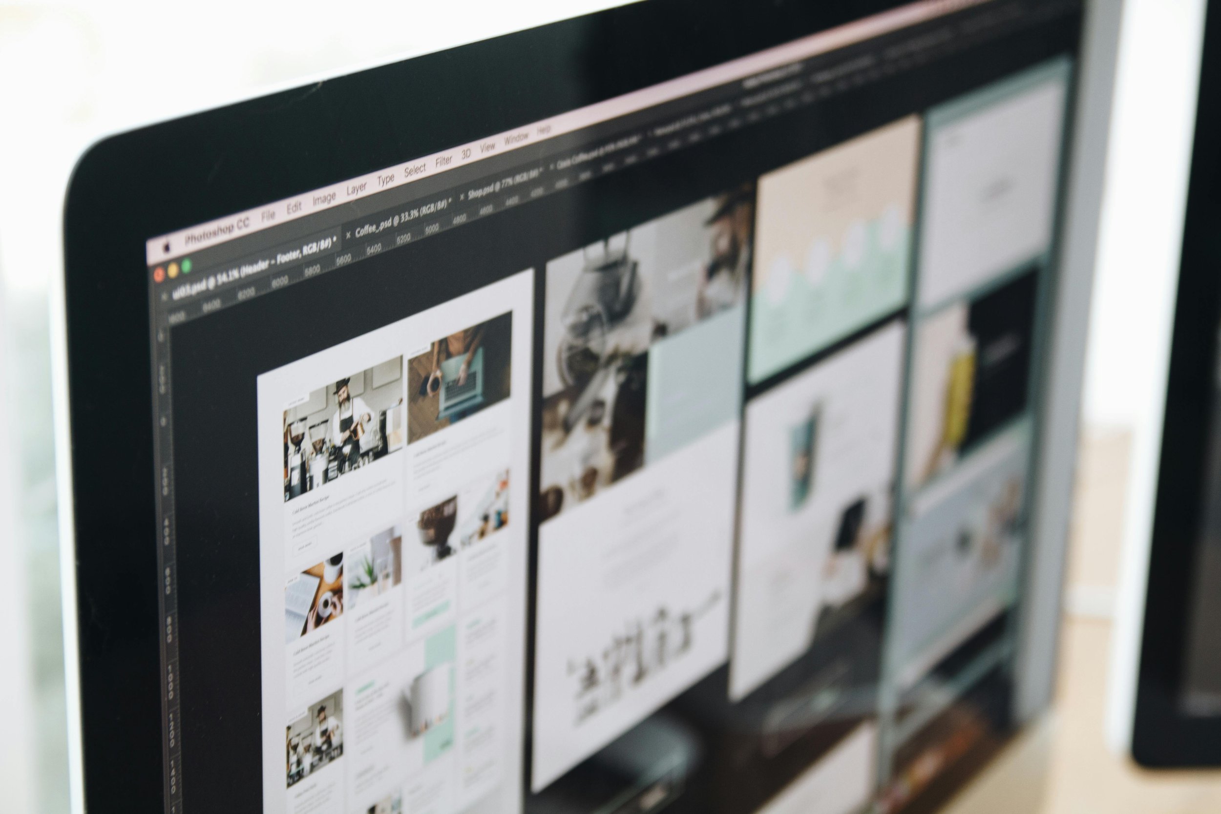 A laptop screen shows a website design in progress