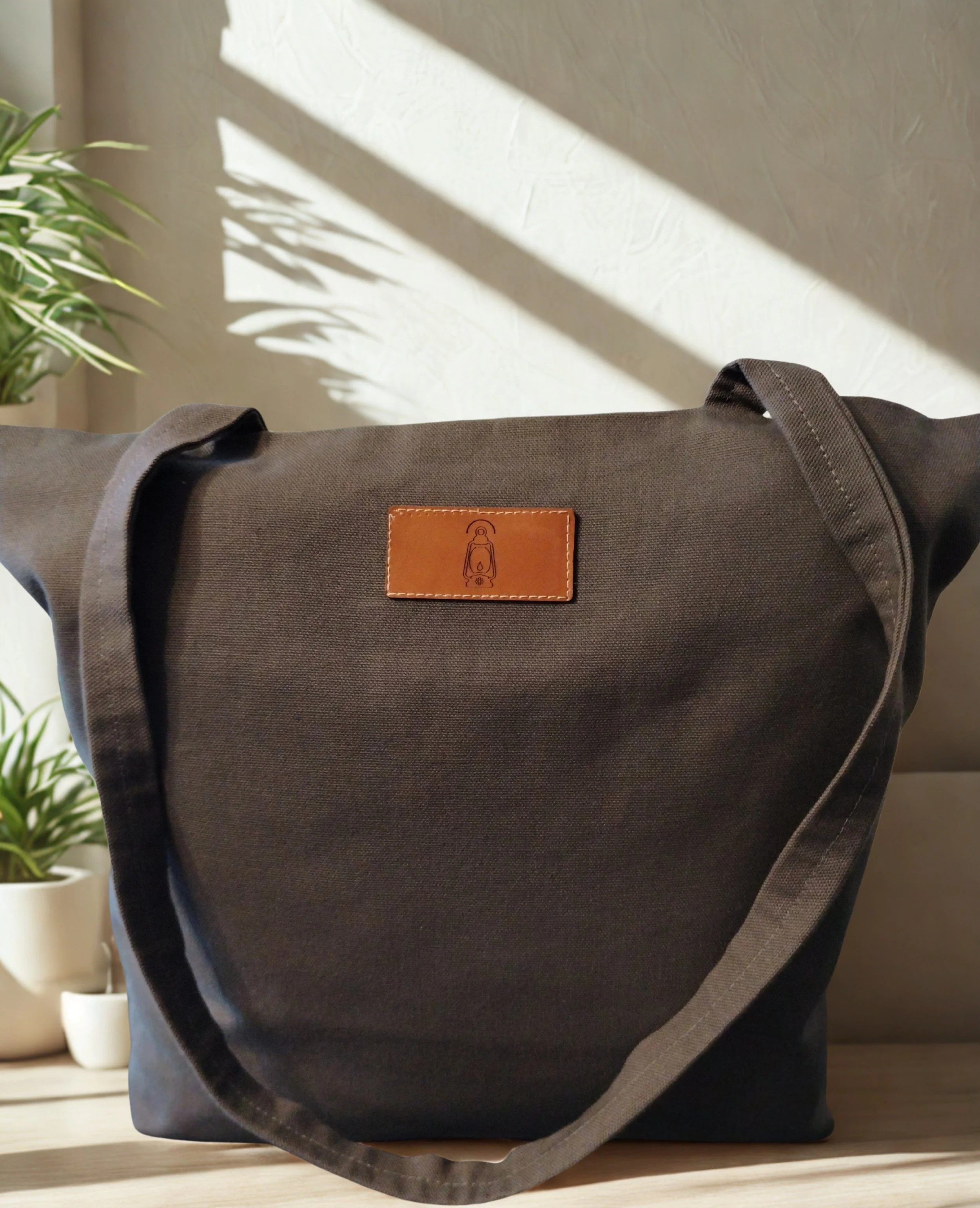 Dark gray handmade duck canvas tote bag with leather lantern label and long shoulder straps