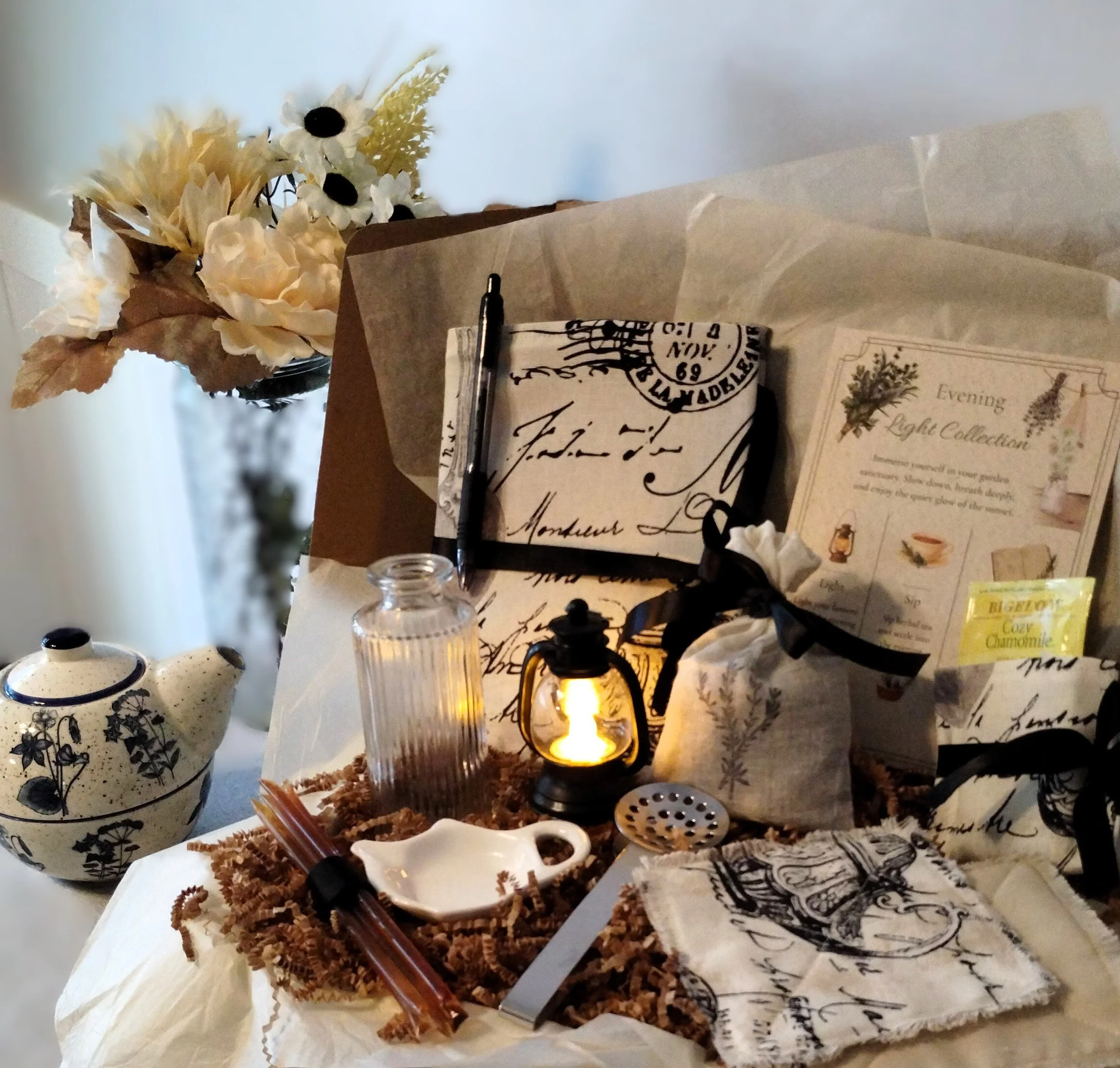 Evening Light gift box with handmade journal cover, tea accessories, lavender sachet, frayed coasters and glowing mini lantern.