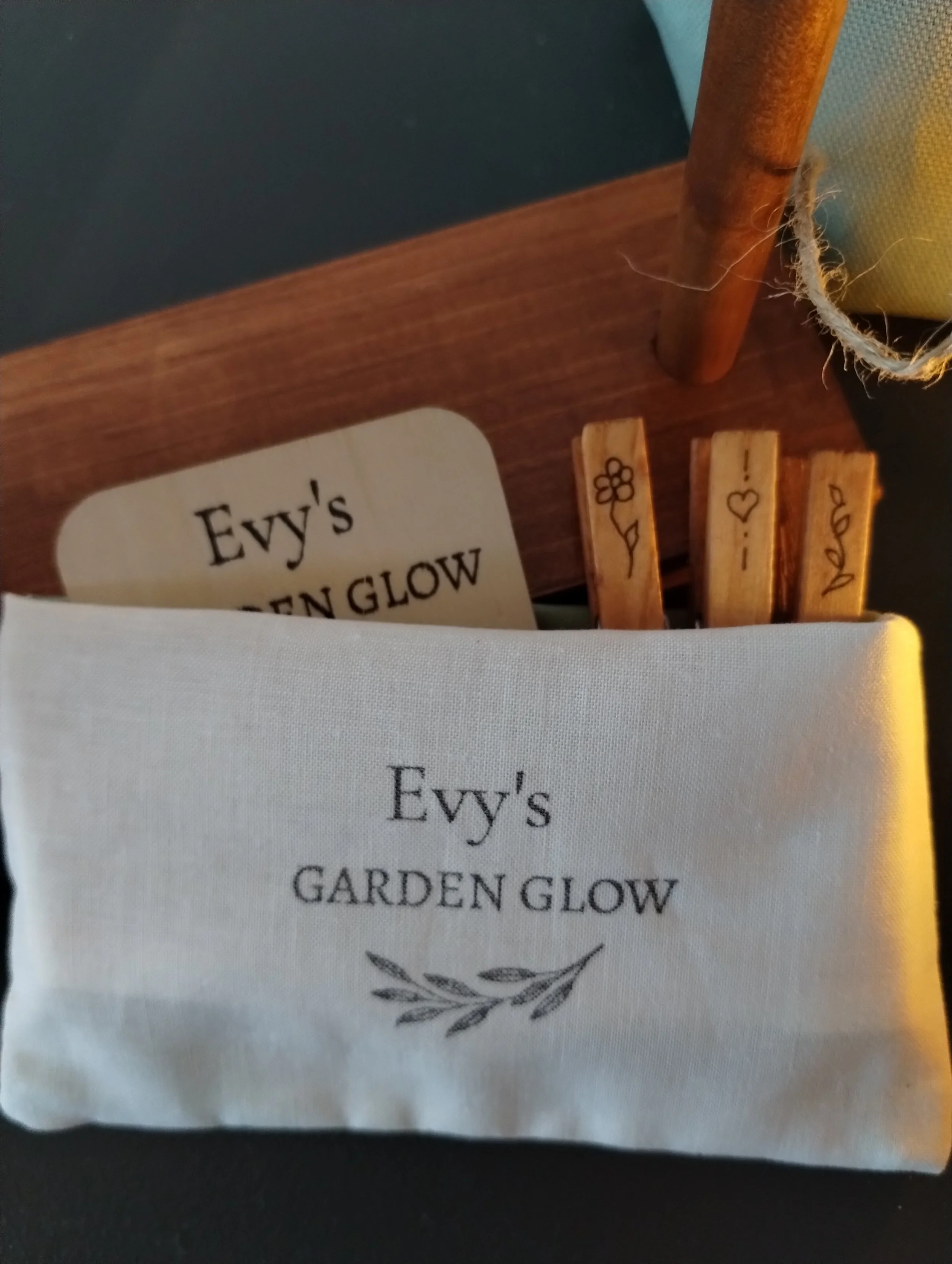 Herb Garden Collections herb drying bundle showing a white fabric pouch with wood tag and 3 repurposed clothespins for hanging herbs