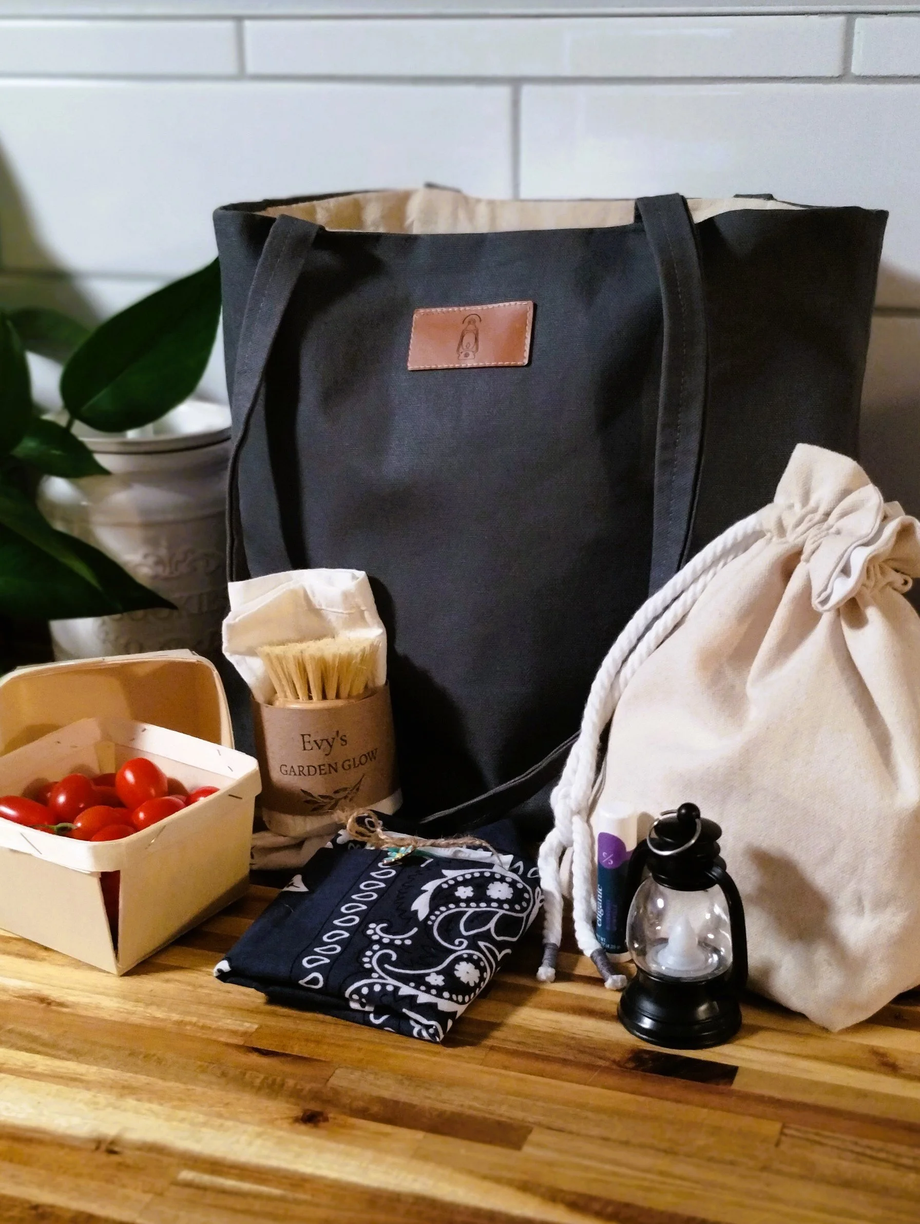 Market Collection displayed with handmade charcoal tote, canvas gathering pouch, wooden berry baskets, produce accessories and mini lantern.
