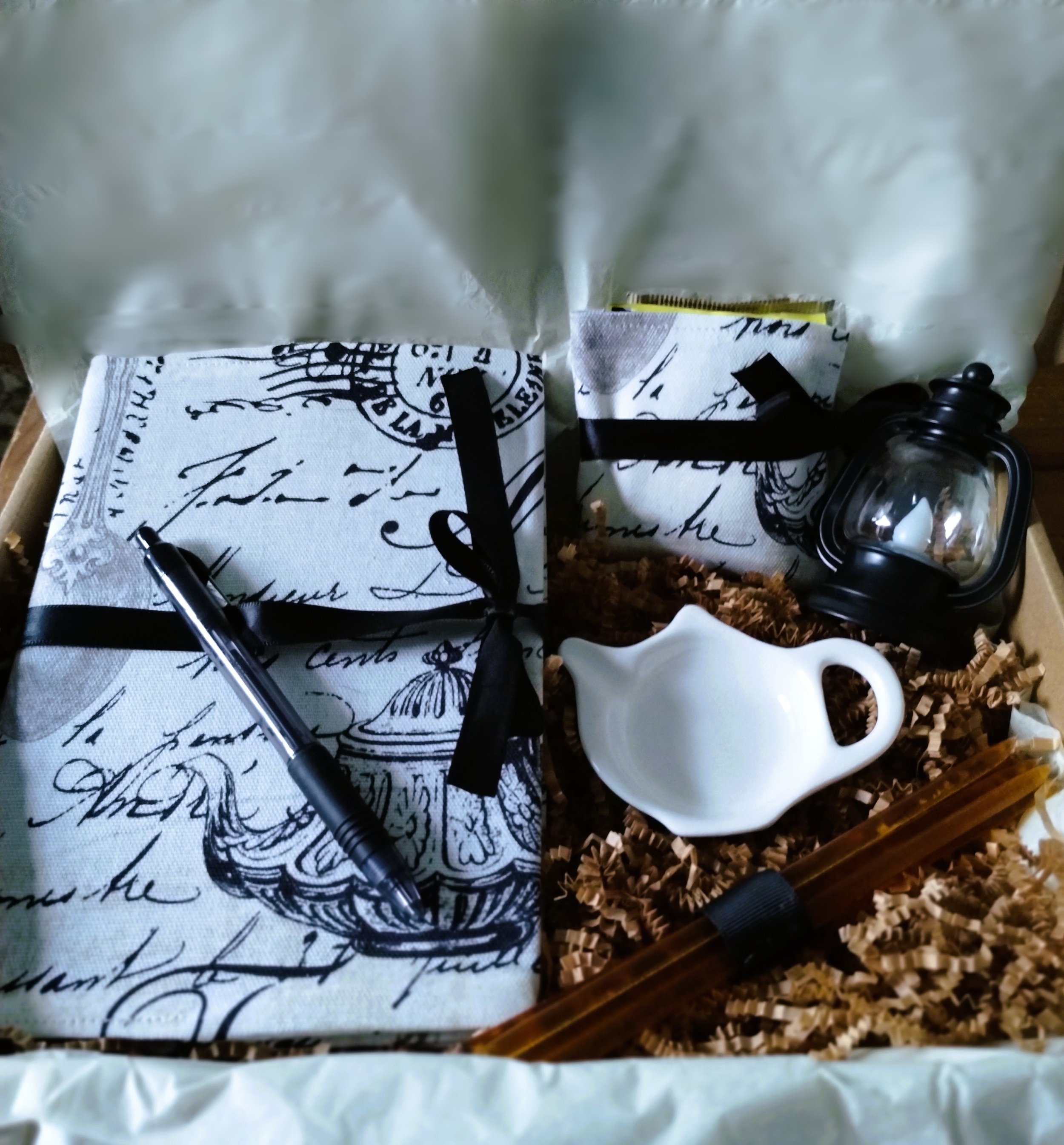 Cozy Evening gift set packaged in a box with fabric-covered journal, tea pouch, honey sticks, tea bag holder and mini lantern.