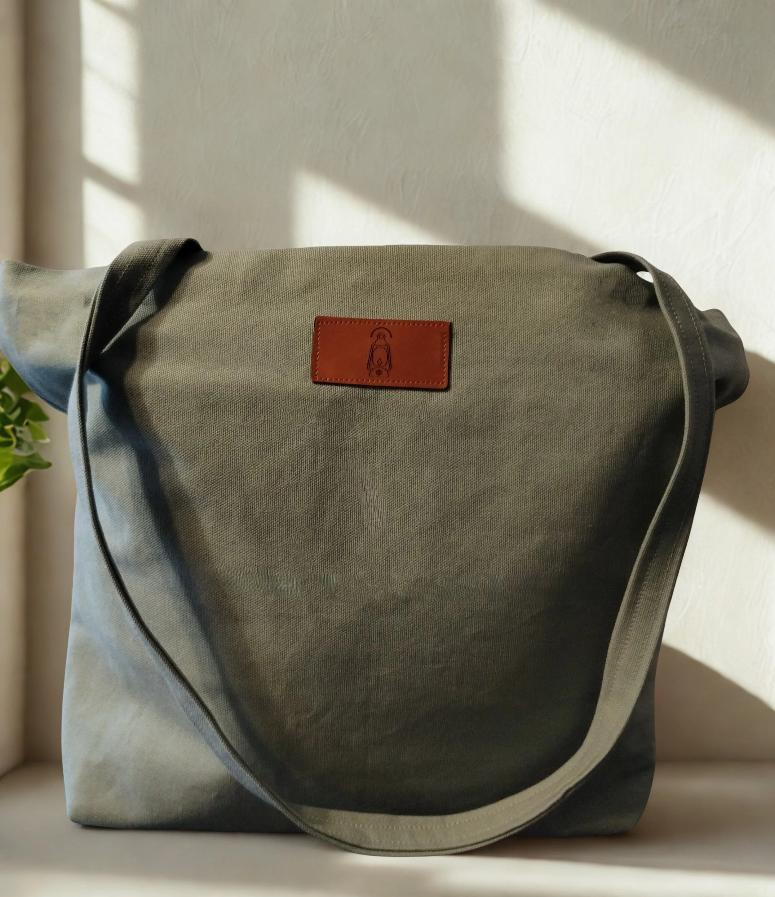 Sage green handmade duck canvas tote bag with leather lantern label and long shoulder straps