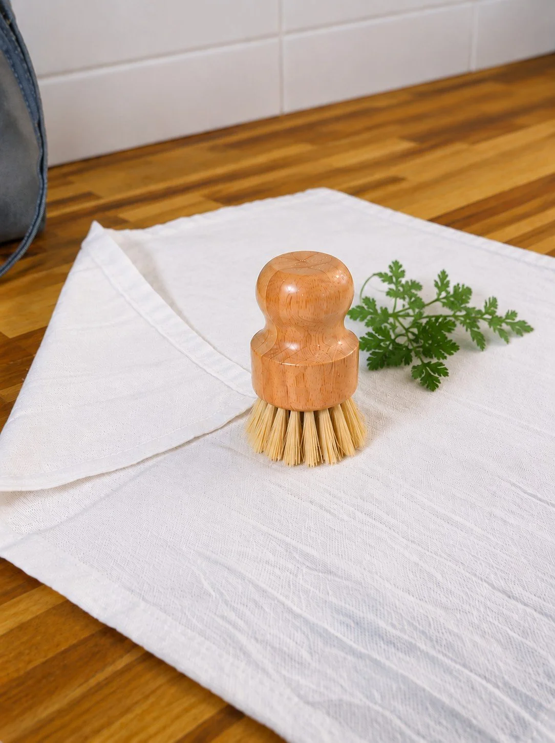 Natural cotton produce cloth with handcrafted wooden vegetable brush.