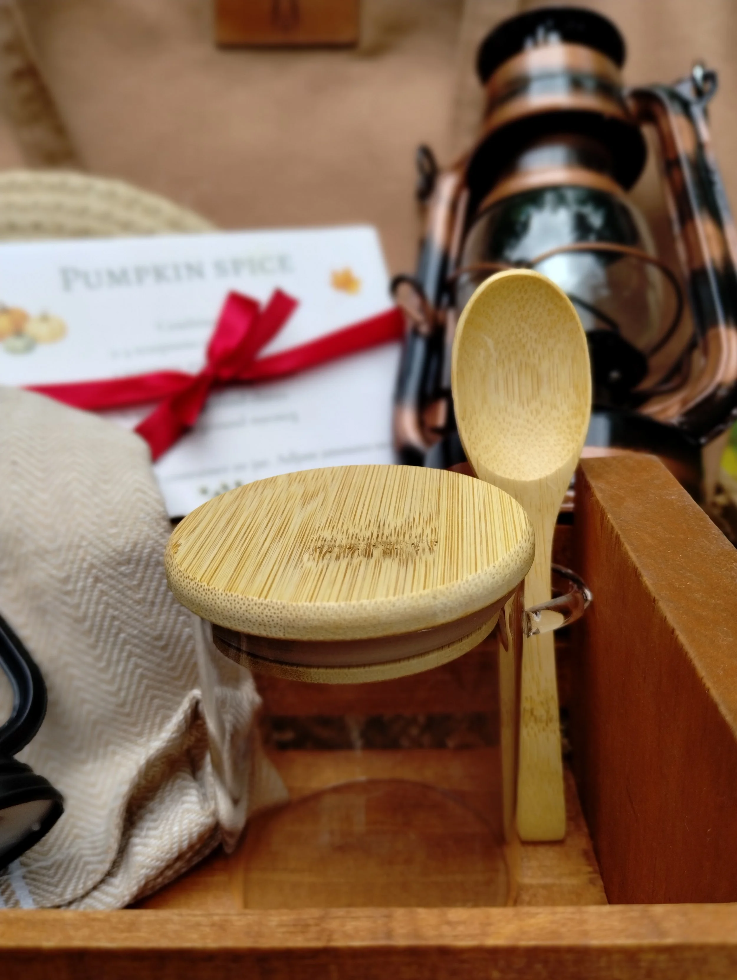 Evys Garden Glow Autum Afternoon closeup of spice jar and wooden crate with tote and recipe cards in the background