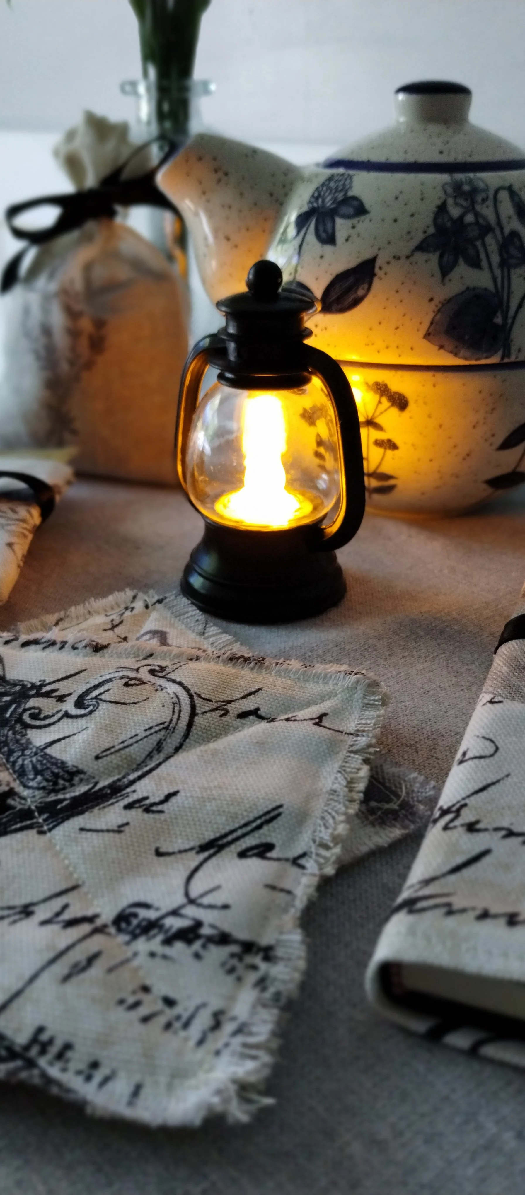 Glowing mini lantern displayed with handmade frayed coasters and fabric-covered journal from the Evening Light gift set.