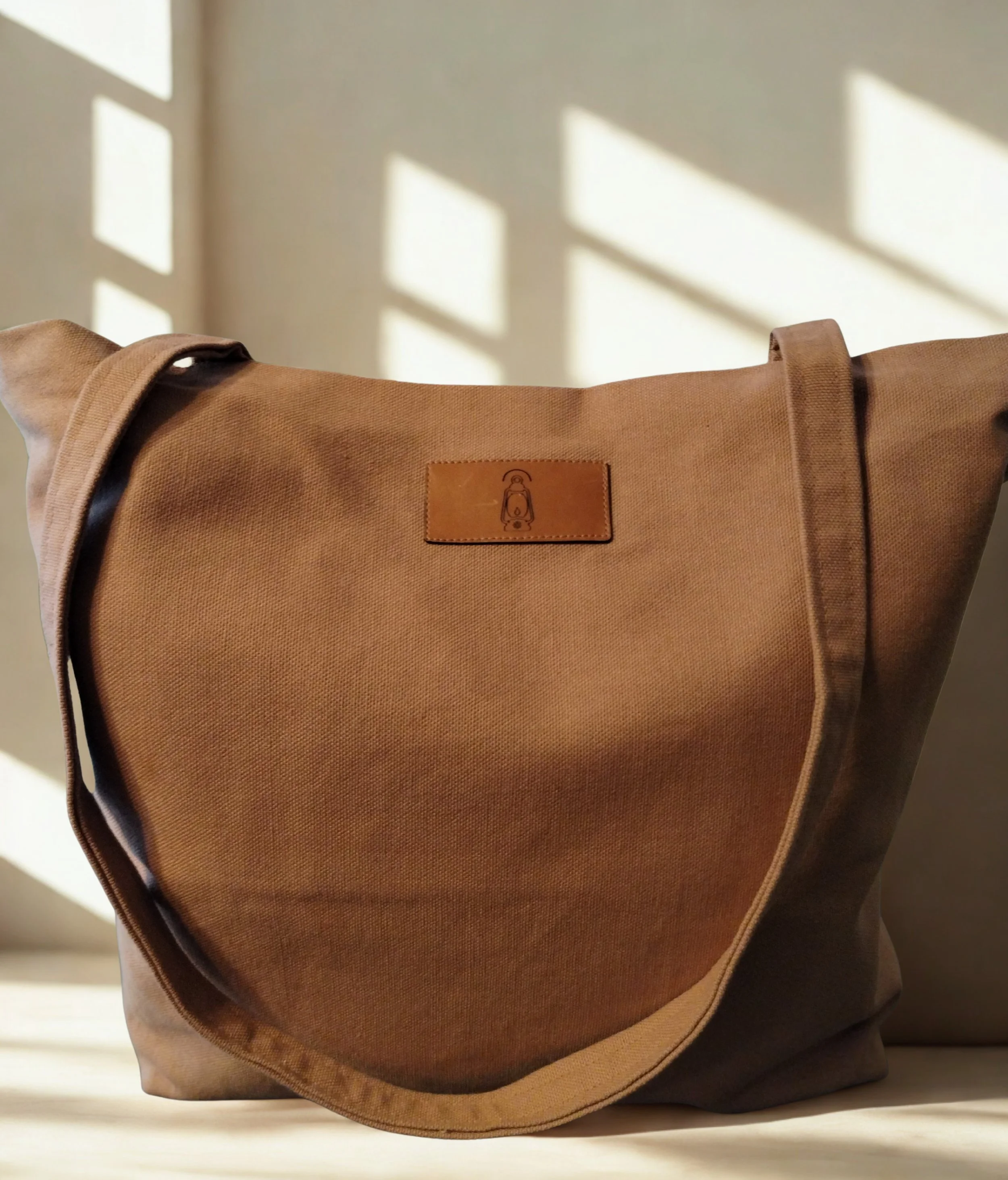 Nutmeg brown handmade duck canvas tote bag with leather lantern label and long shoulder straps