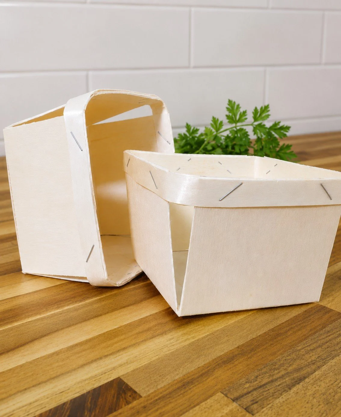 Two handcrafted wooden berry baskets for gathering fresh fruits and vegetables.