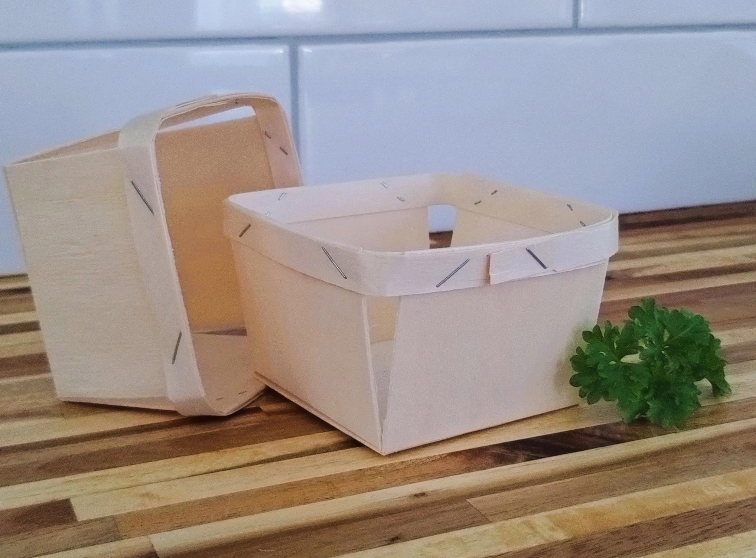 Two lightweight wooden berry baskets included in the Market Collection for gathering fresh garden produce.
