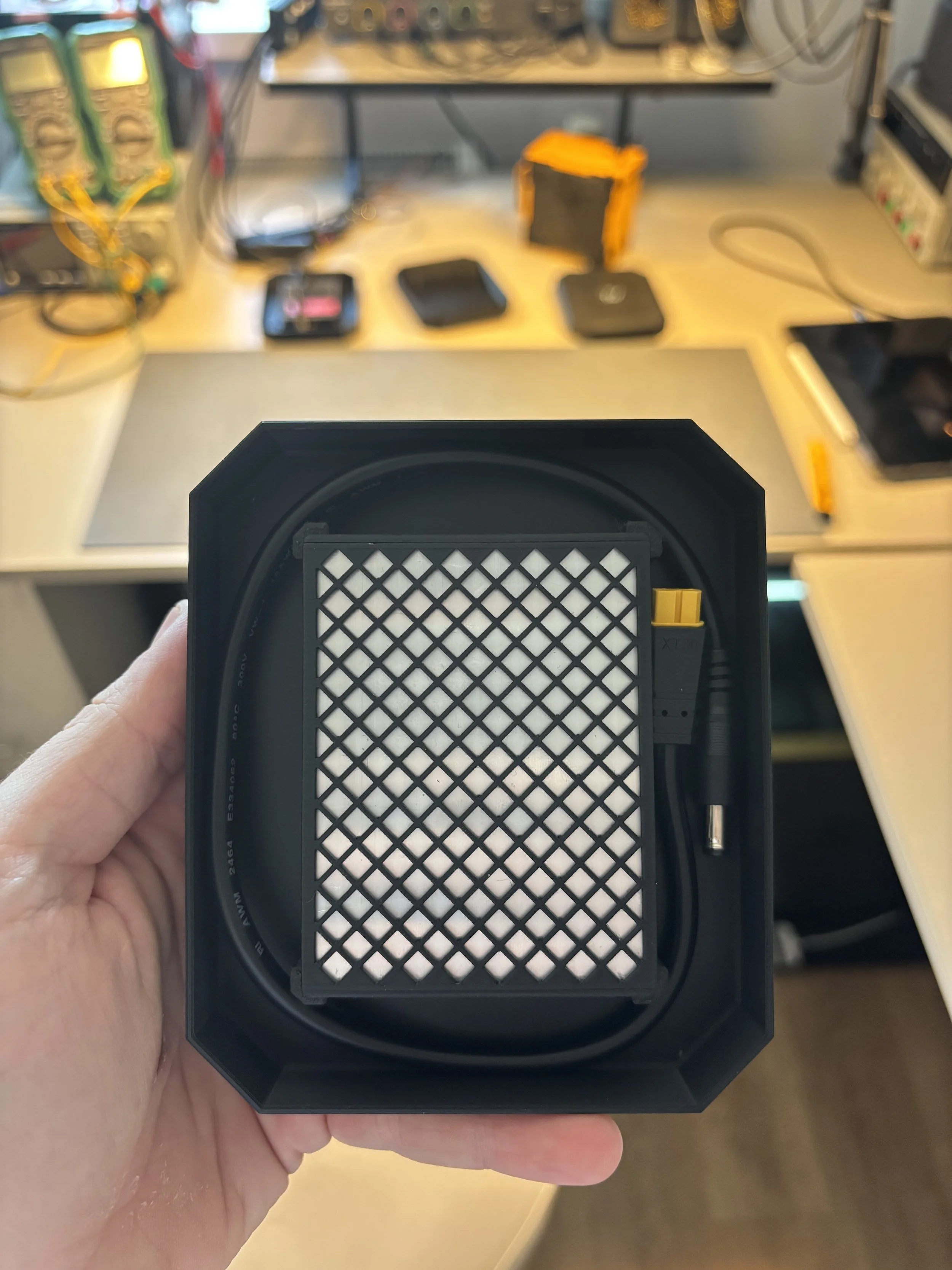 A customer holding TravelWatt charger case with its contents.