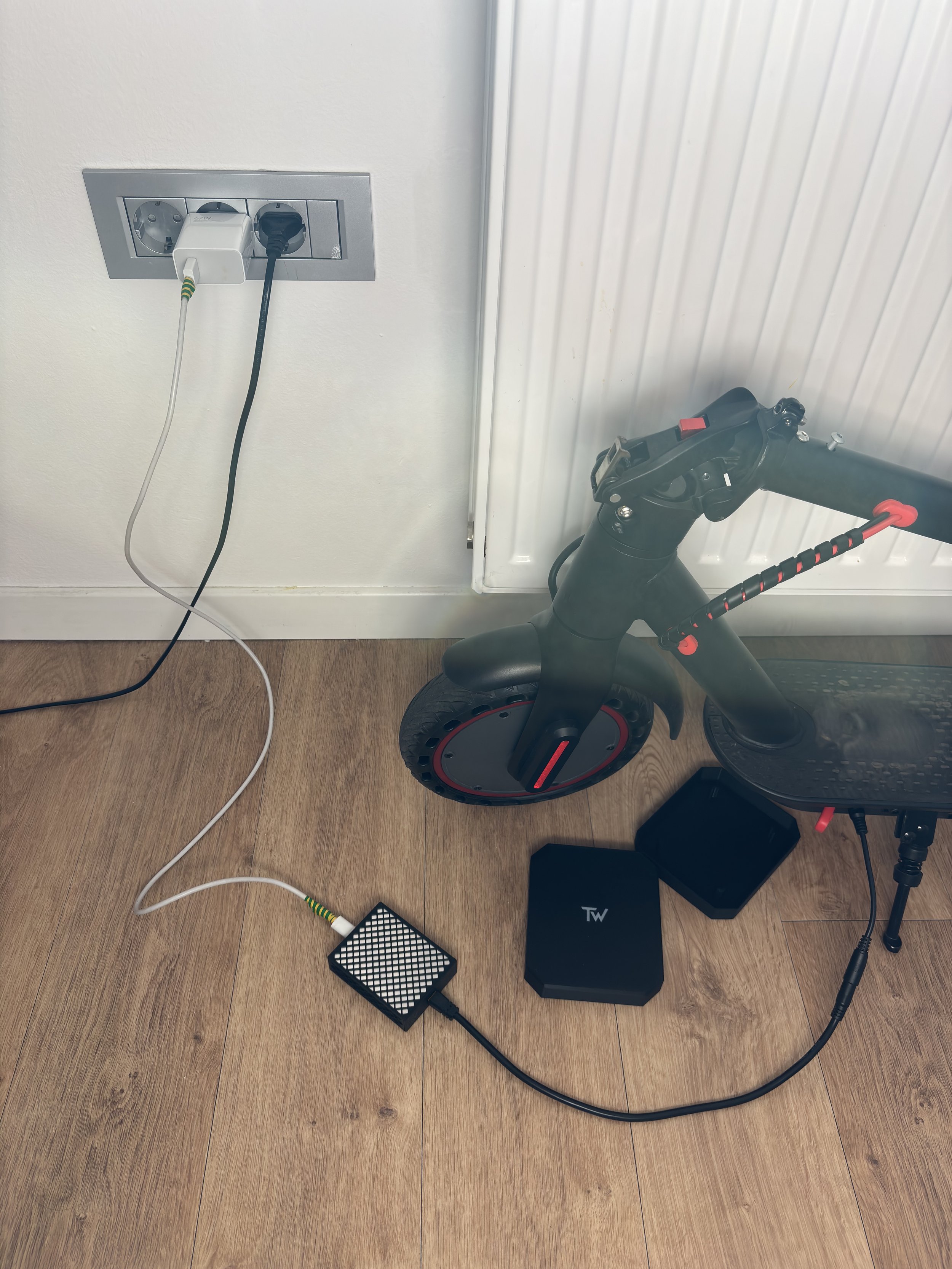 A user charging his eScooter with a phone fast charger using TravelWatt