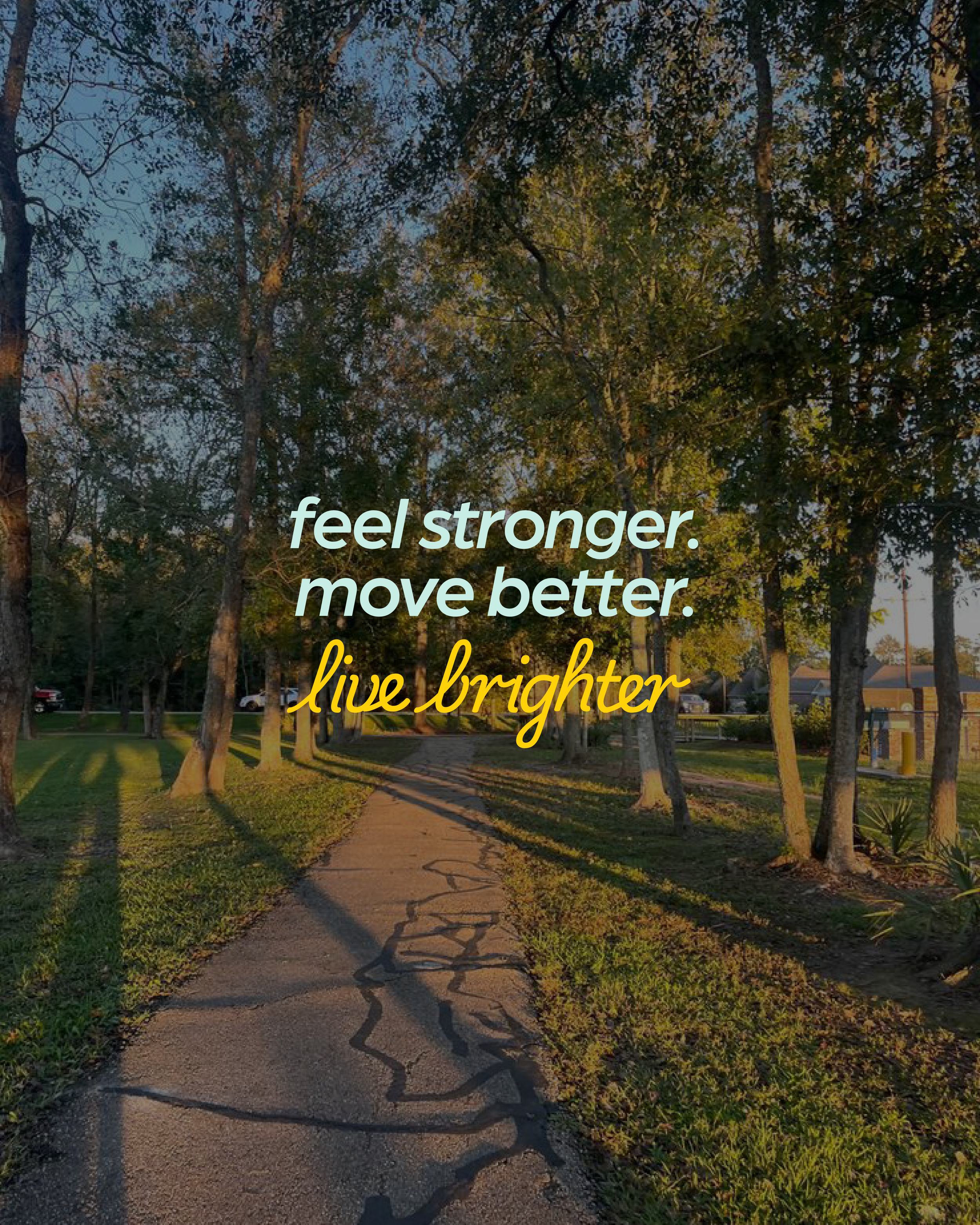 A trail through a park with freshly cut grass on the sides and trees casting long shadows, illuminated by warm sunlight, with a handwritten text overlay that says, 'feel stronger, move better, live brighter'.