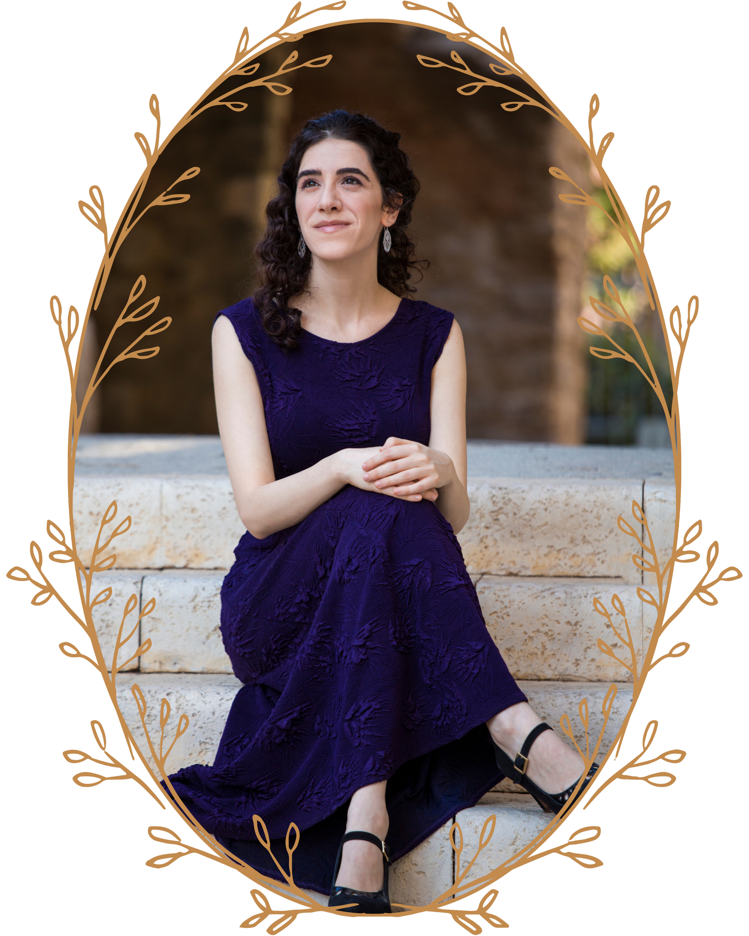 Photo of Adi Denner, wearing a purple gown and sitting on stone steps