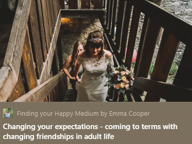 A bride holding a bouquet walking down a wooden staircase with a young girl beside her, in an outdoor setting.