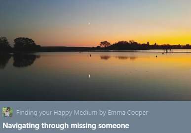 Sunset over a calm lake with silhouetted trees and a clear sky with a small crescent moon