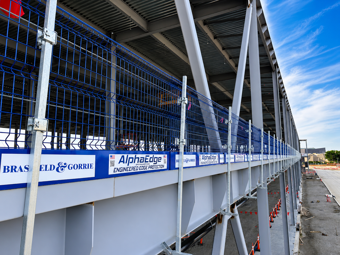 AlphaEdge® engineered edge protection system installed on a commercial construction project, providing temporary perimeter fall protection for elevated work areas.