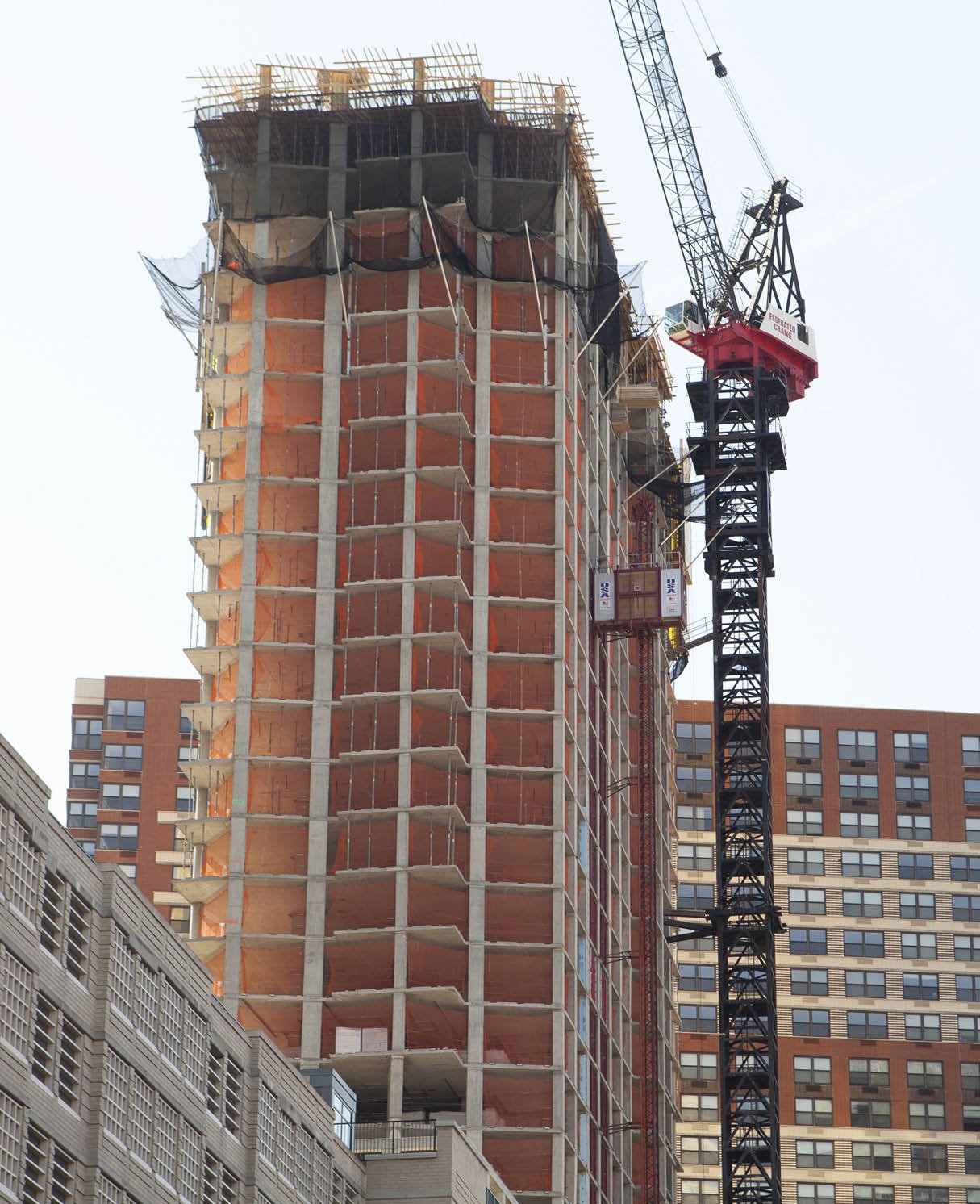 Temporary construction safety netting installed on a high-rise commercial building to provide perimeter protection during active construction.