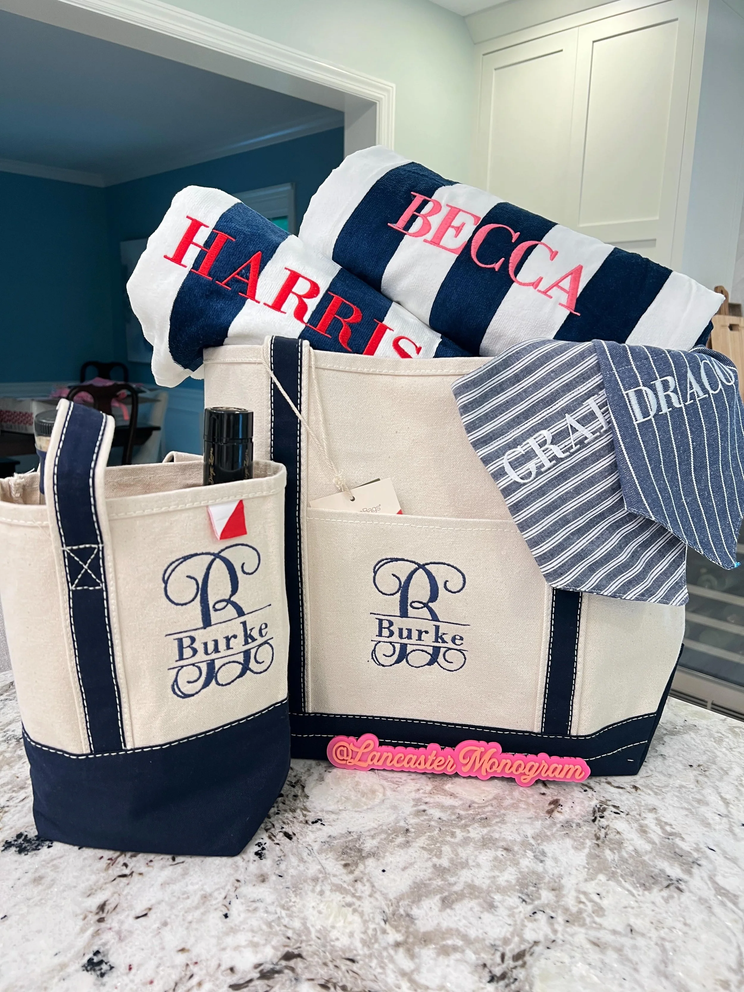 ✨ In this set:
🍷 Wine tote with split monogram
👜 Medium boat tote (a Lancaster Monogram fave &mdash; this one holds everything)
🏖️ Matching cabana stripe beach towels, personalized for each of them
🐾 Coordinating dog bandanas for the four-legged 