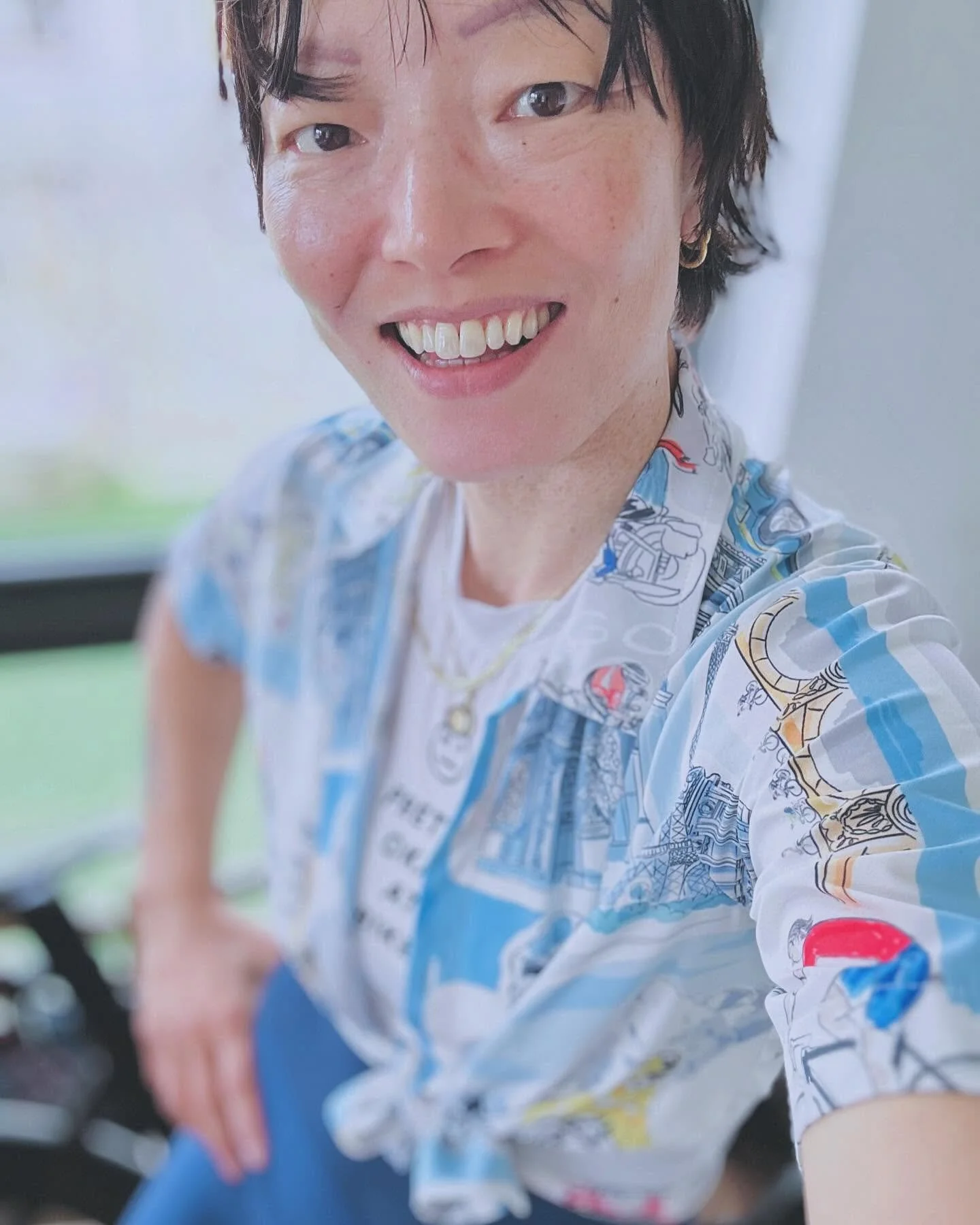 Portrait of Aterfa founder and therapist Jo with short dark hair, smiling with visible teeth, wearing a cycling kit.