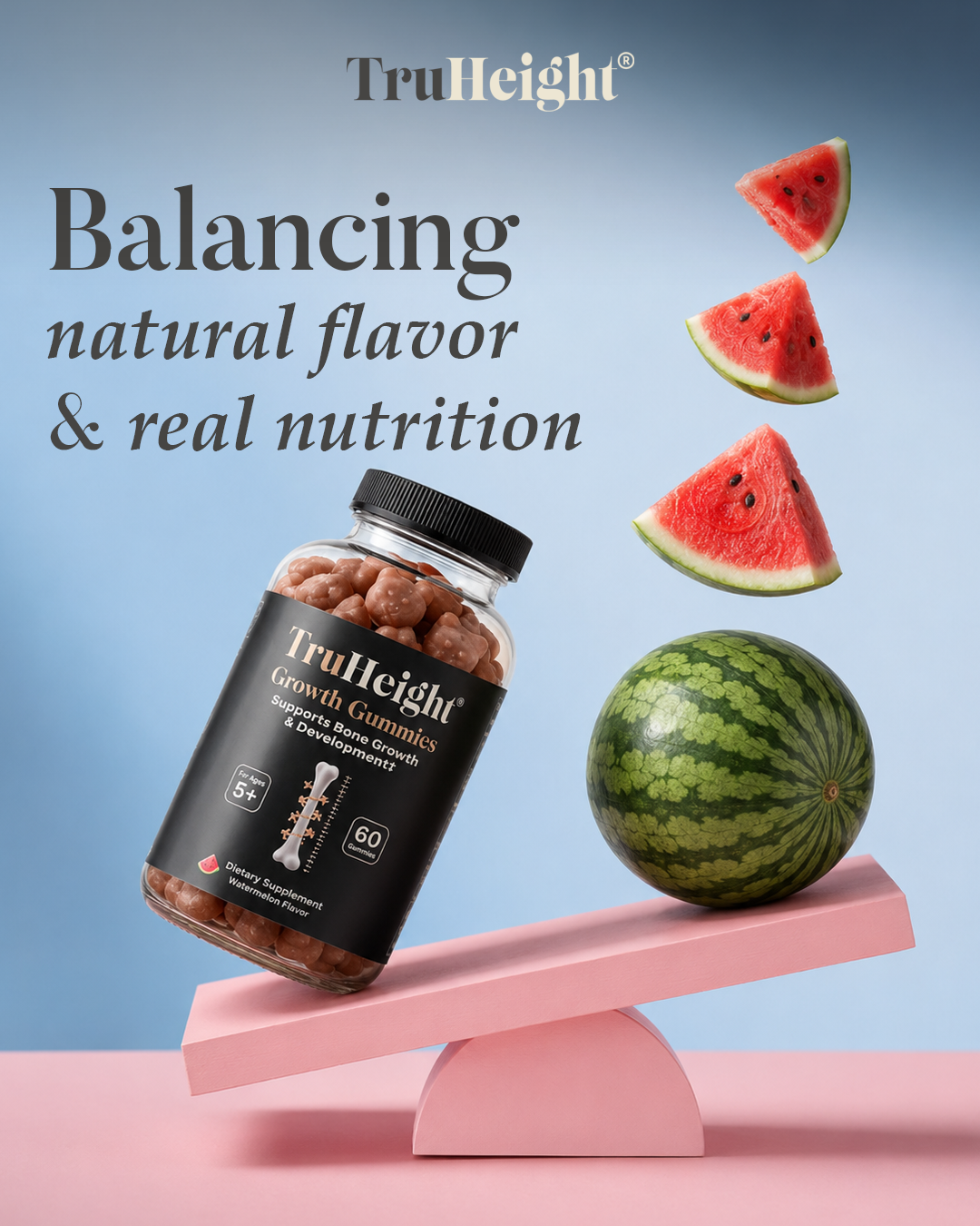 A bottle of TruHeight Growth Gummies balanced on a pink seesaw, with a watermelon and watermelon slices arranged to resemble a see-saw's other side, against a blue background with text about balancing natural flavor and nutrition.