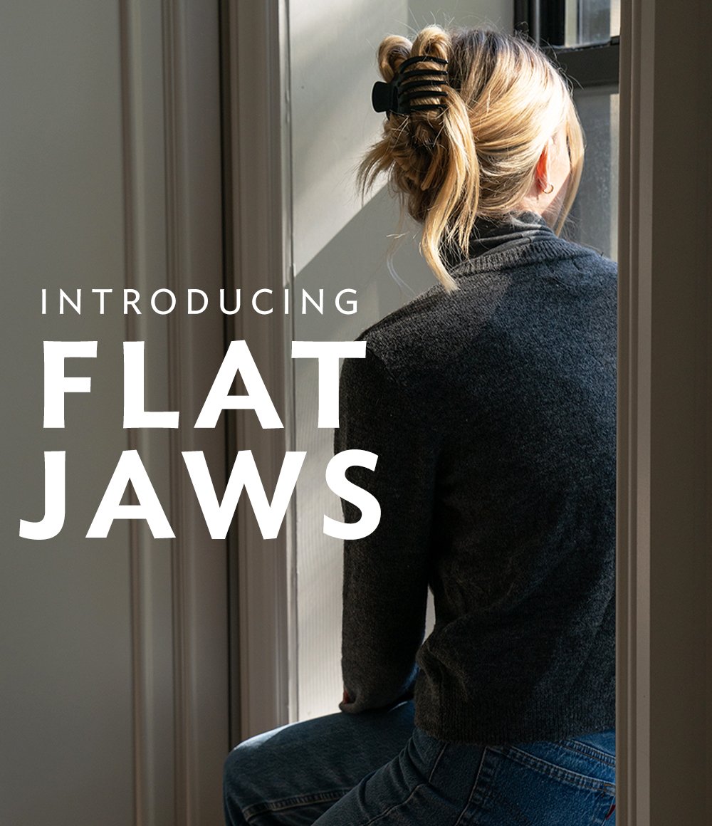 Woman sitting on a windowsill looking outside, with text overlay saying "Introducing Flat Jaws".