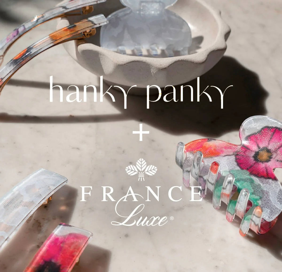 A close-up image featuring a ceramic bowl, several colorful hair clips with floral designs, and a shadow cast on a light-colored surface, with overlaid text reading 'hanky panky + FRANCE Luce'.