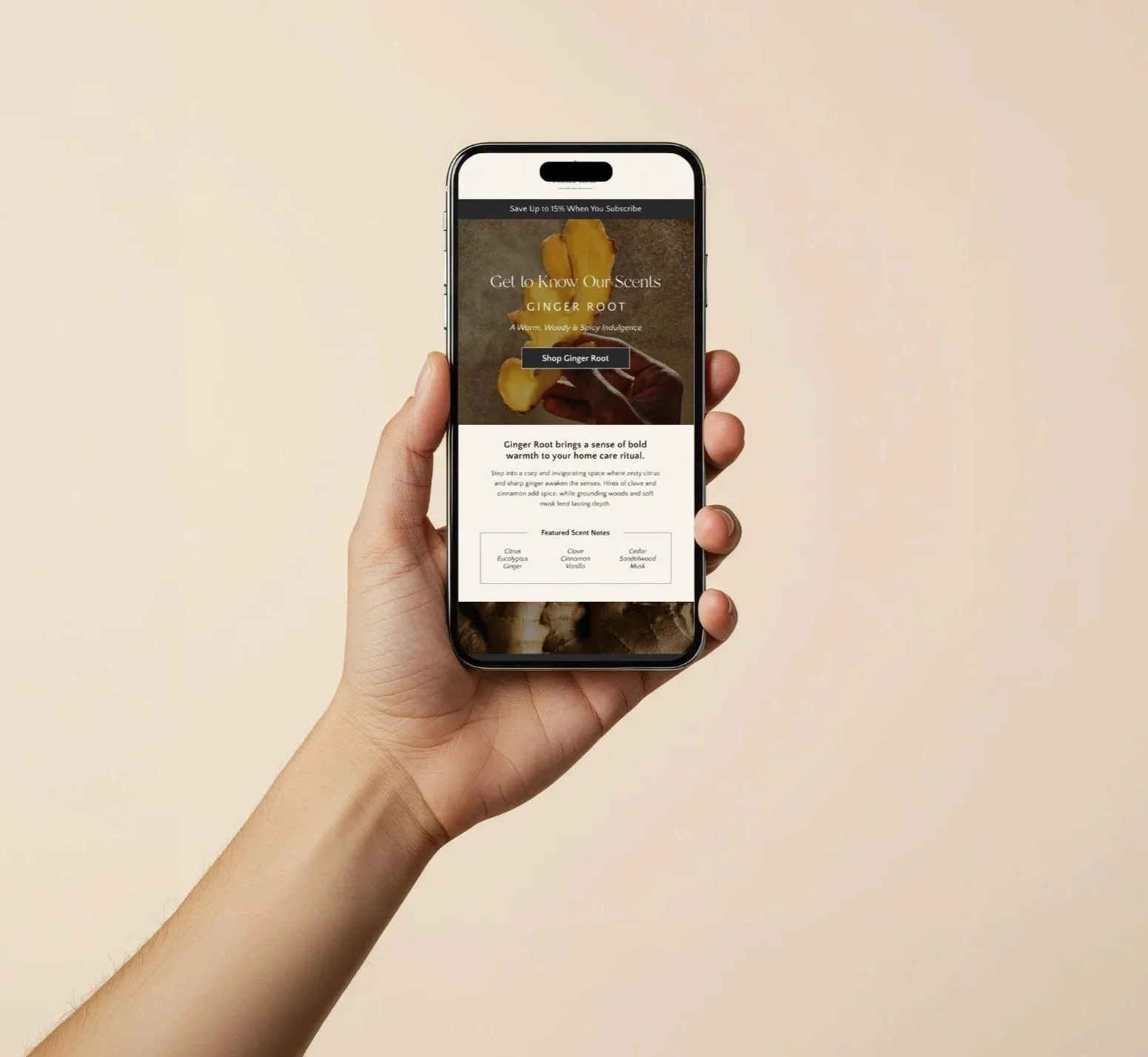 A person holding a smartphone displaying a webpage about ginger root scents, with a beige background.