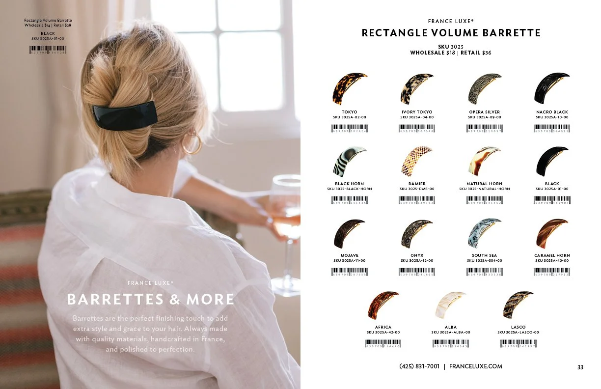 Page from a catalog featuring hair barrettes. A woman with blonde hair, wearing a white shirt, is shown from behind, holding a glass, with a window in the background. The right side displays various hair barrettes with their names, SKUs, and barcodes, under the heading "FRANCE LUXE RECTANGLE VOLUME BARRETTE."