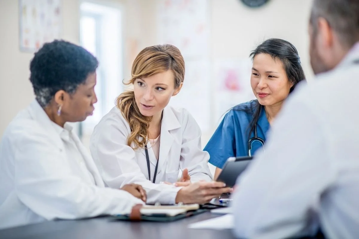 Group of providers and doctors talking together.
