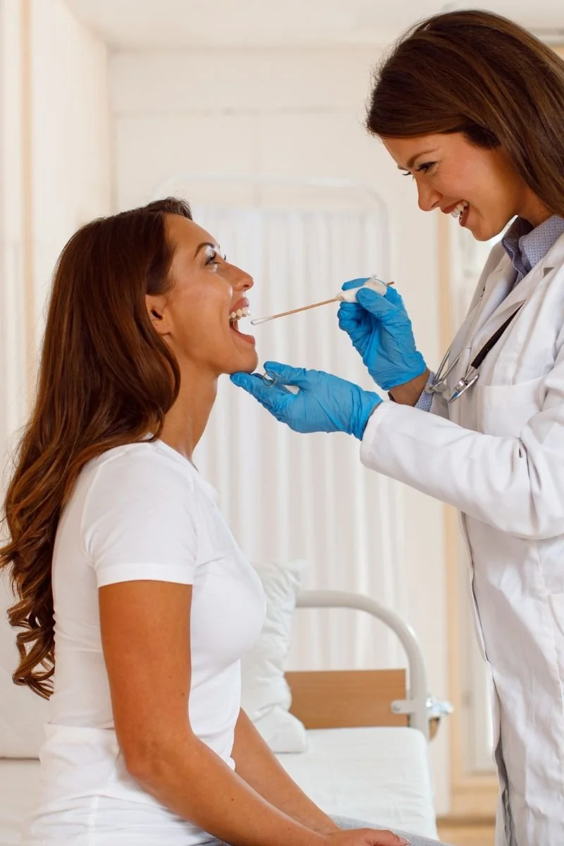 IndyCare provider completing a throat culture.