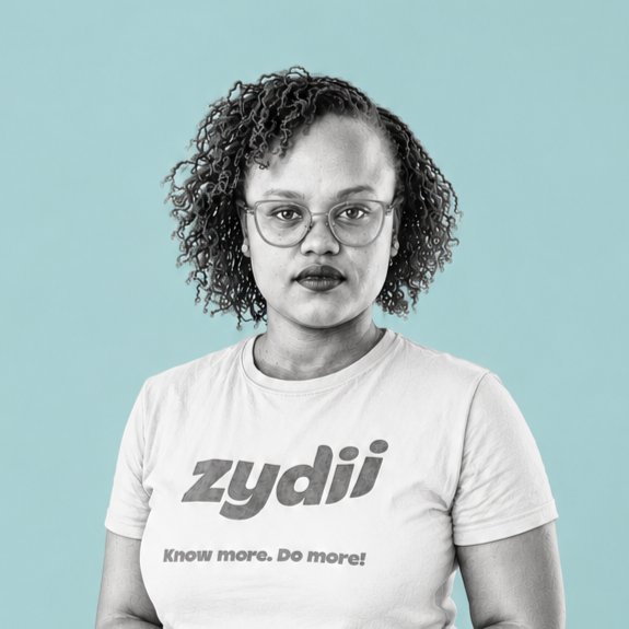 A woman with curly hair and glasses wearing a white t-shirt with the Zydii logo and the slogan "Know more. Do more!" against a light blue background.