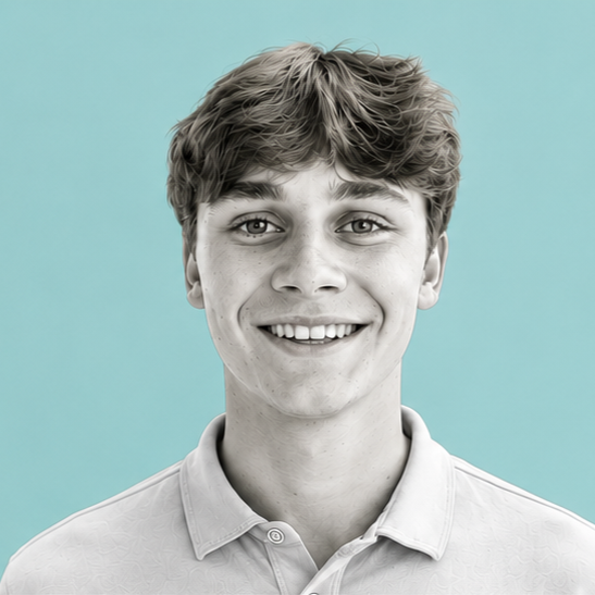 A young man with brown hair and a wide smile, wearing a light-colored collared shirt, against a teal background.