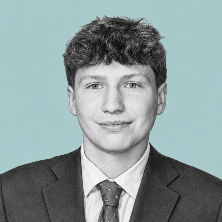 Black and white portrait of a young man with curly hair, wearing a suit and tie, against a plain light background.