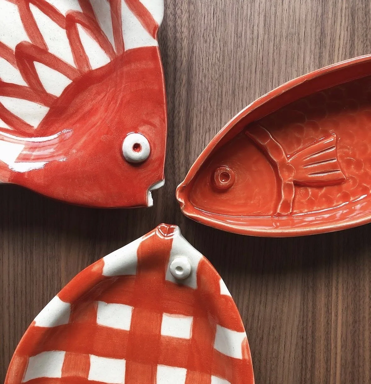 3 coral colored fish on a table