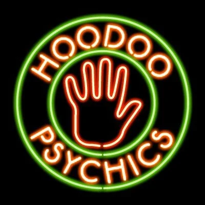 Neon sign with a hand making a peace sign, surrounded by the words 'HOODOO PSYCHICS' in a circular layout.